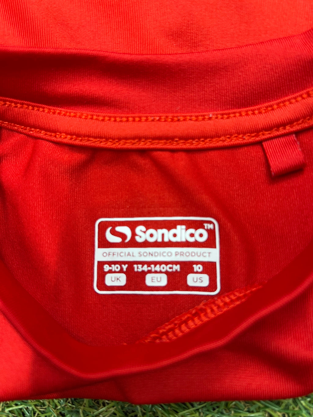 Close-up of the black leggings' side seam and fabric detail showing stitching quality
