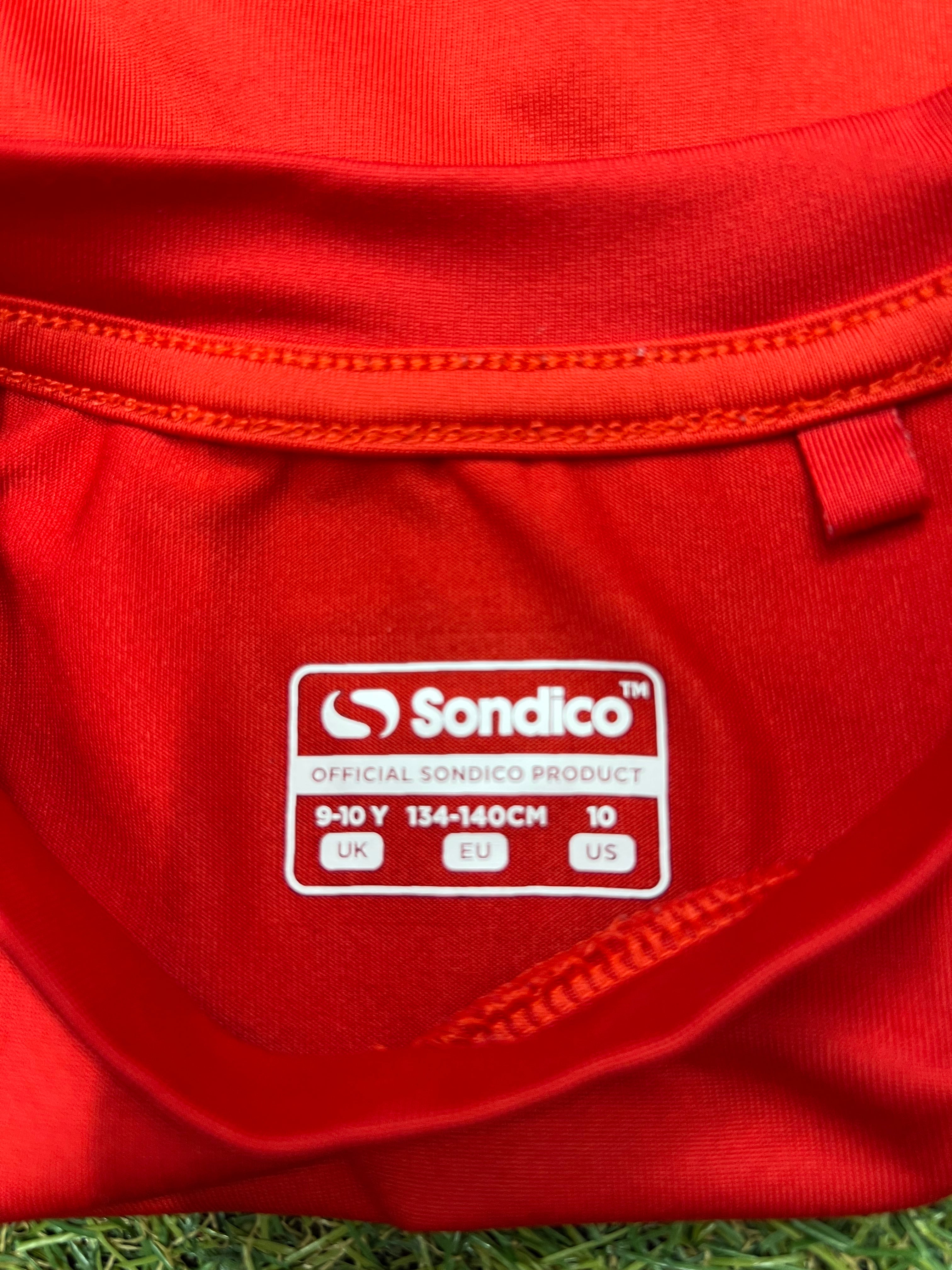 Close-up of the black leggings' side seam and fabric detail showing stitching quality