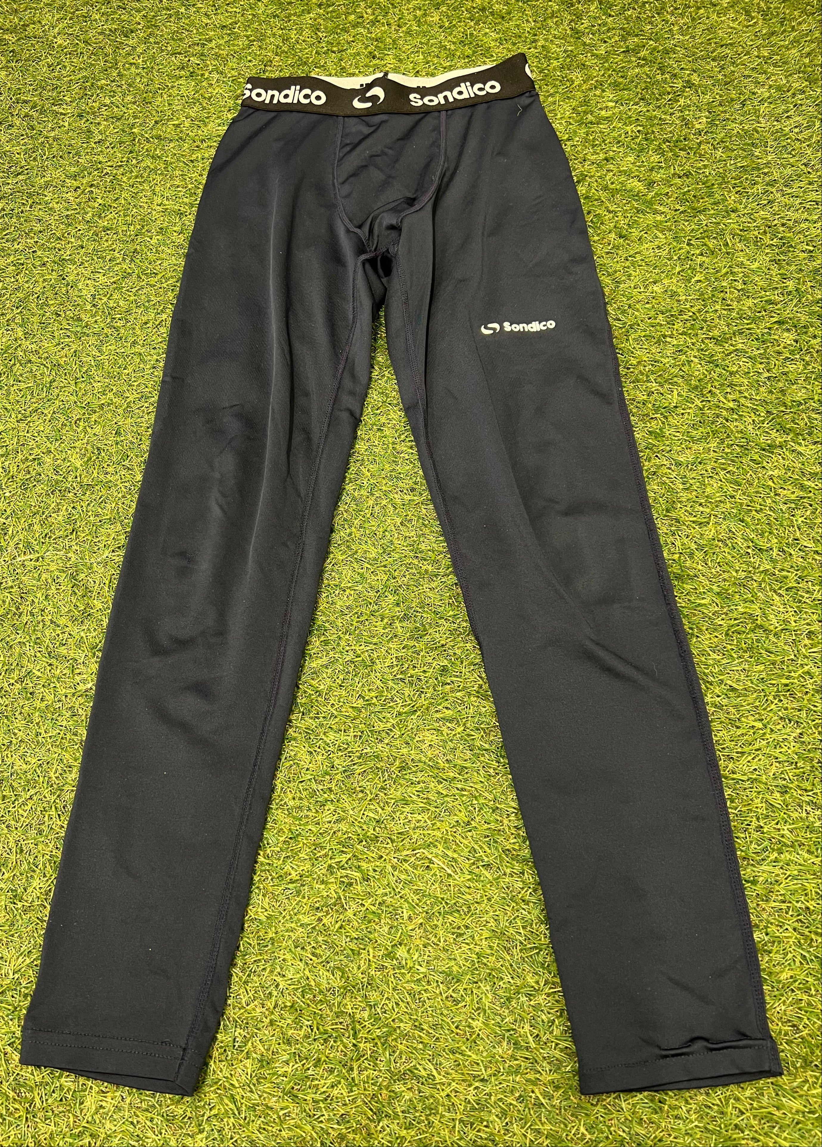 Black Sondico leggings with branded elastic waistband displayed flat on grass