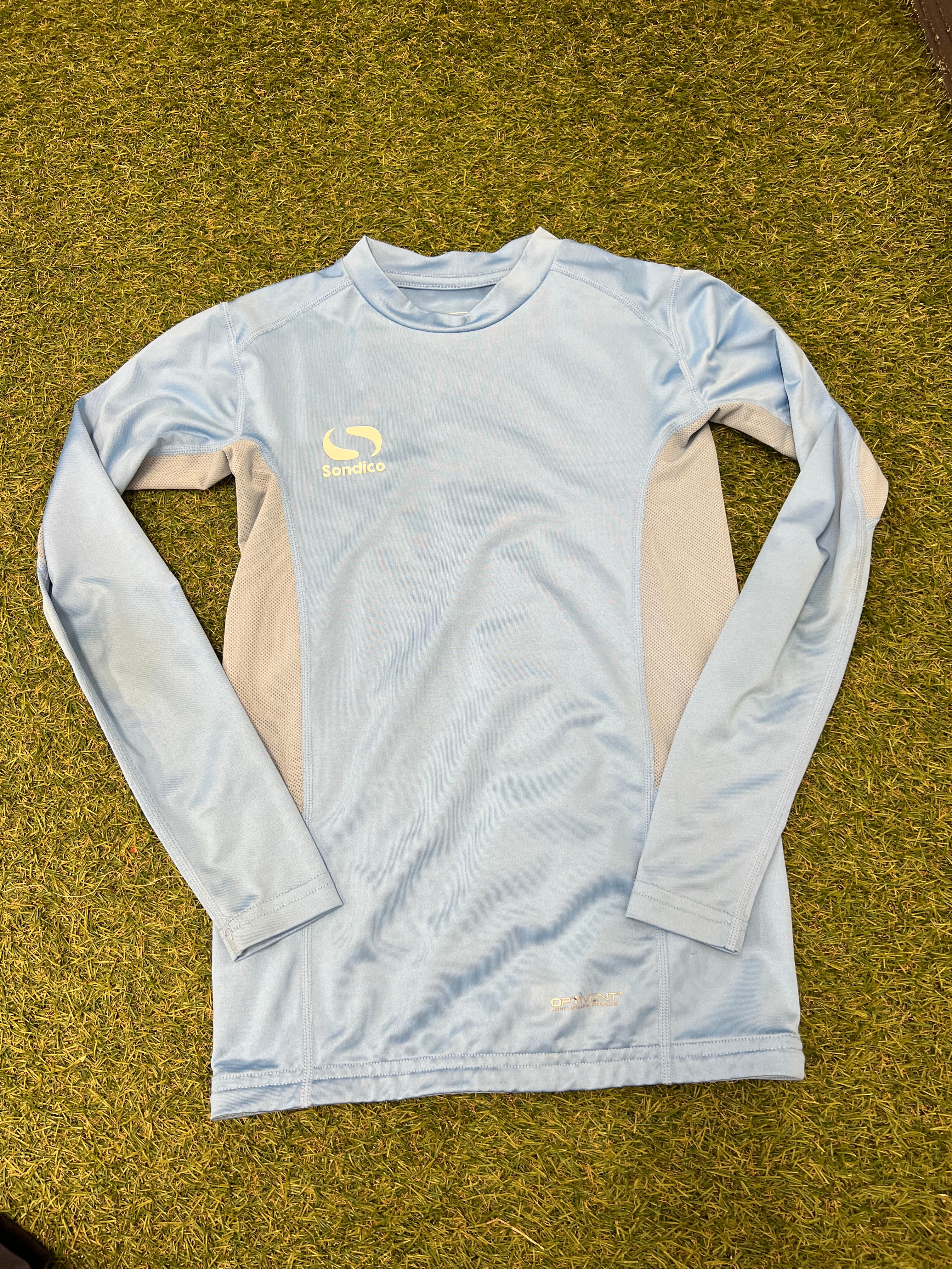 Back view of the sky blue Sondico long-sleeve base layer top showing the logo above the mesh panels