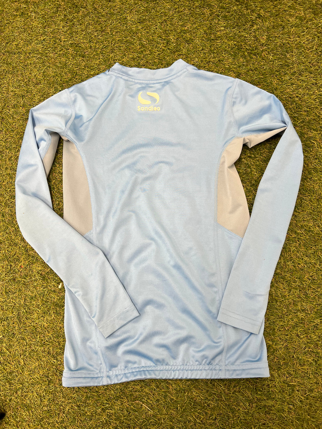 Close-up image of the size label inside the sky blue Sondico top listing kid's size 11-12 years
