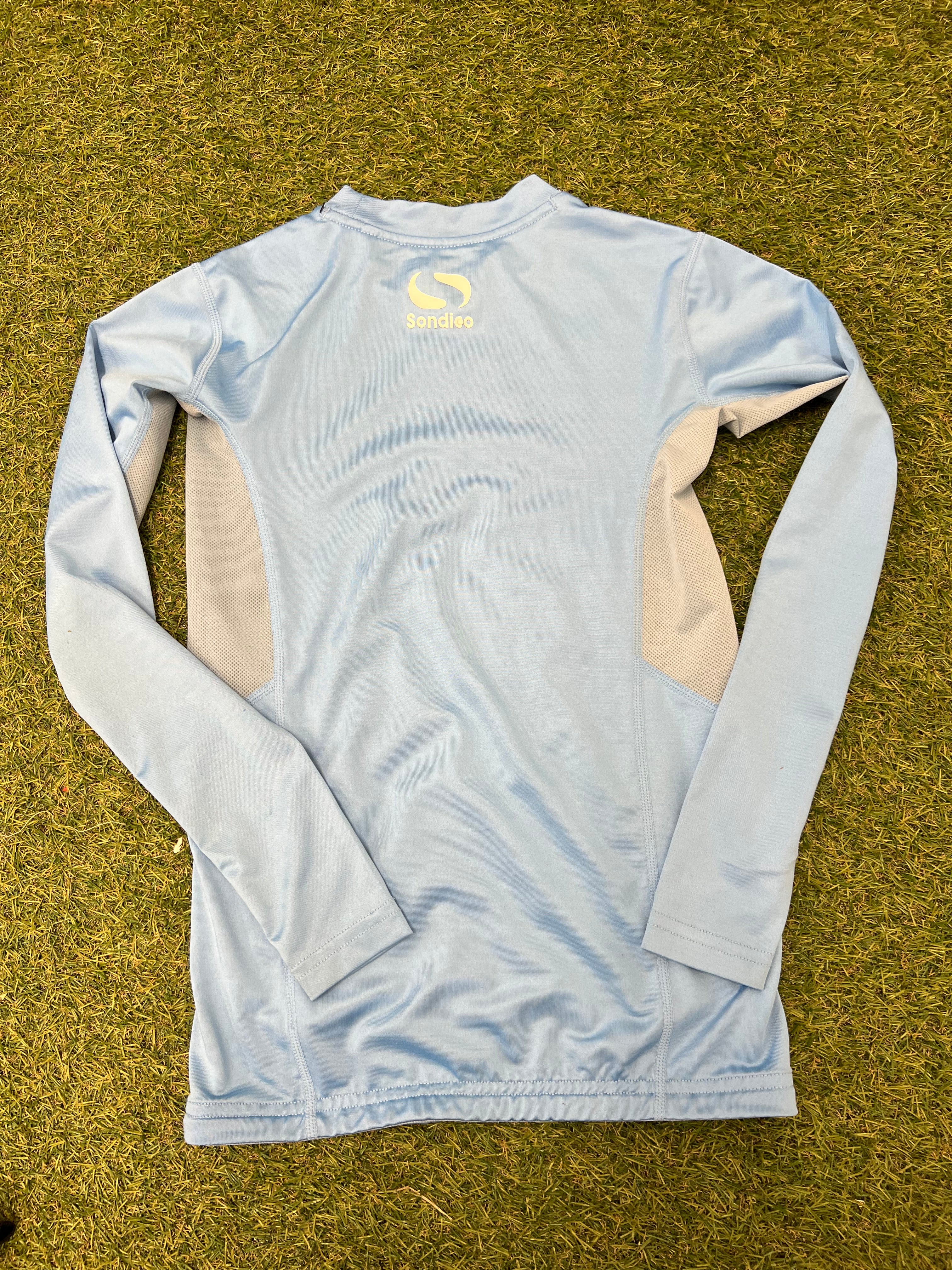 Close-up image of the size label inside the sky blue Sondico top listing kid's size 11-12 years