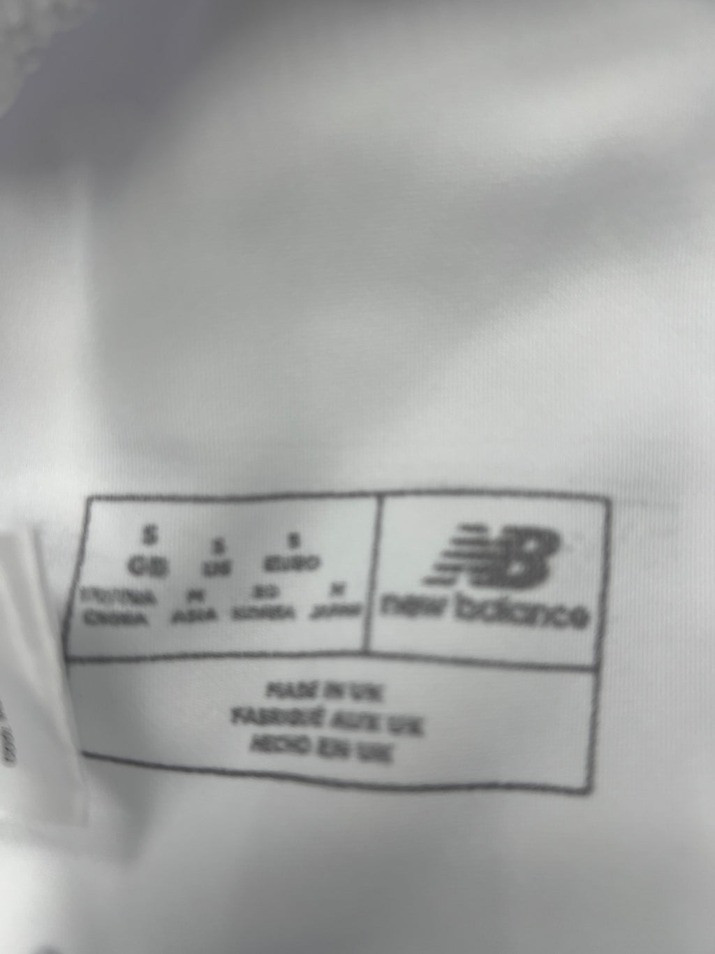 Label inside New Balance cricket trousers showing size small and manufacture details