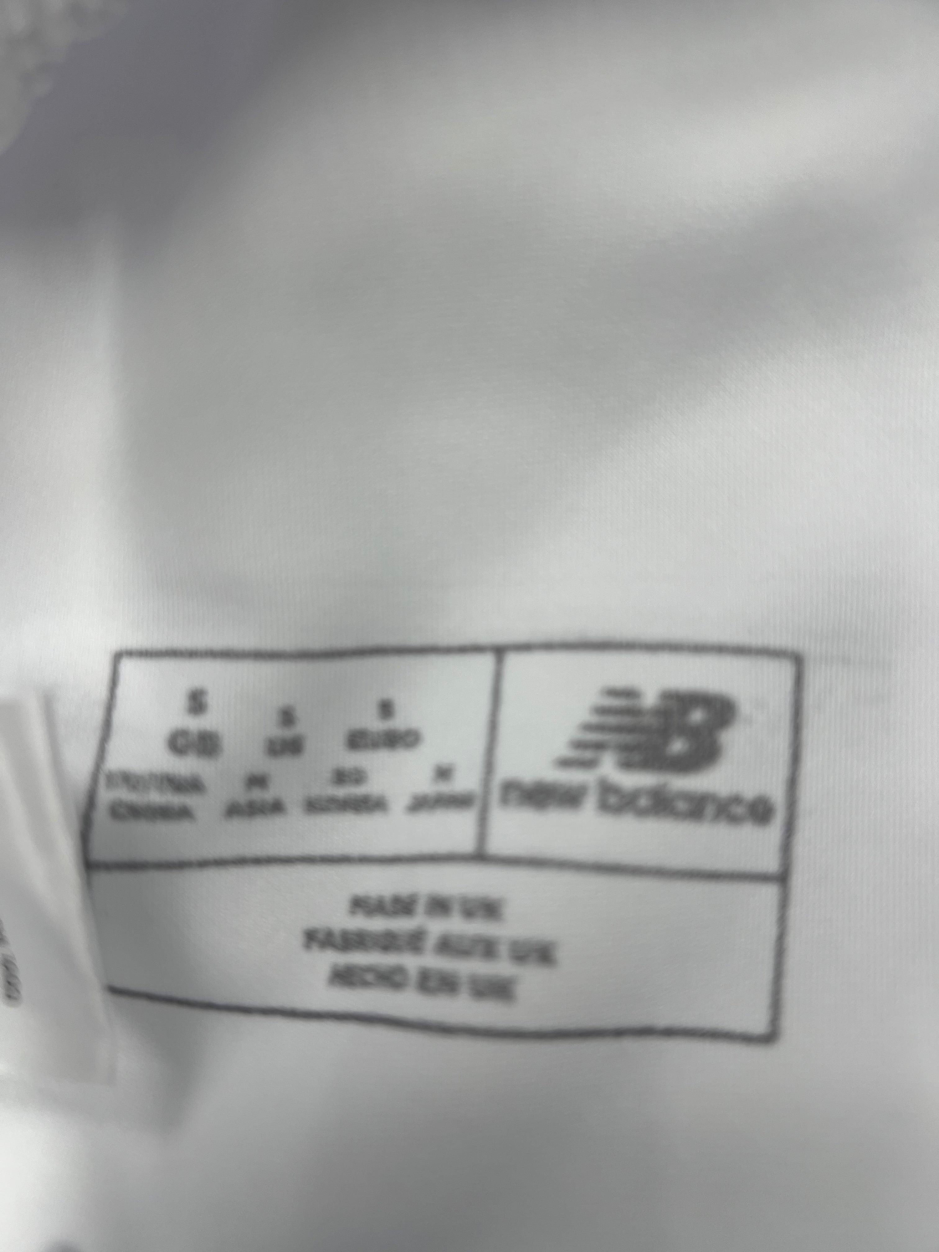 Label inside New Balance cricket trousers showing size small and manufacture details