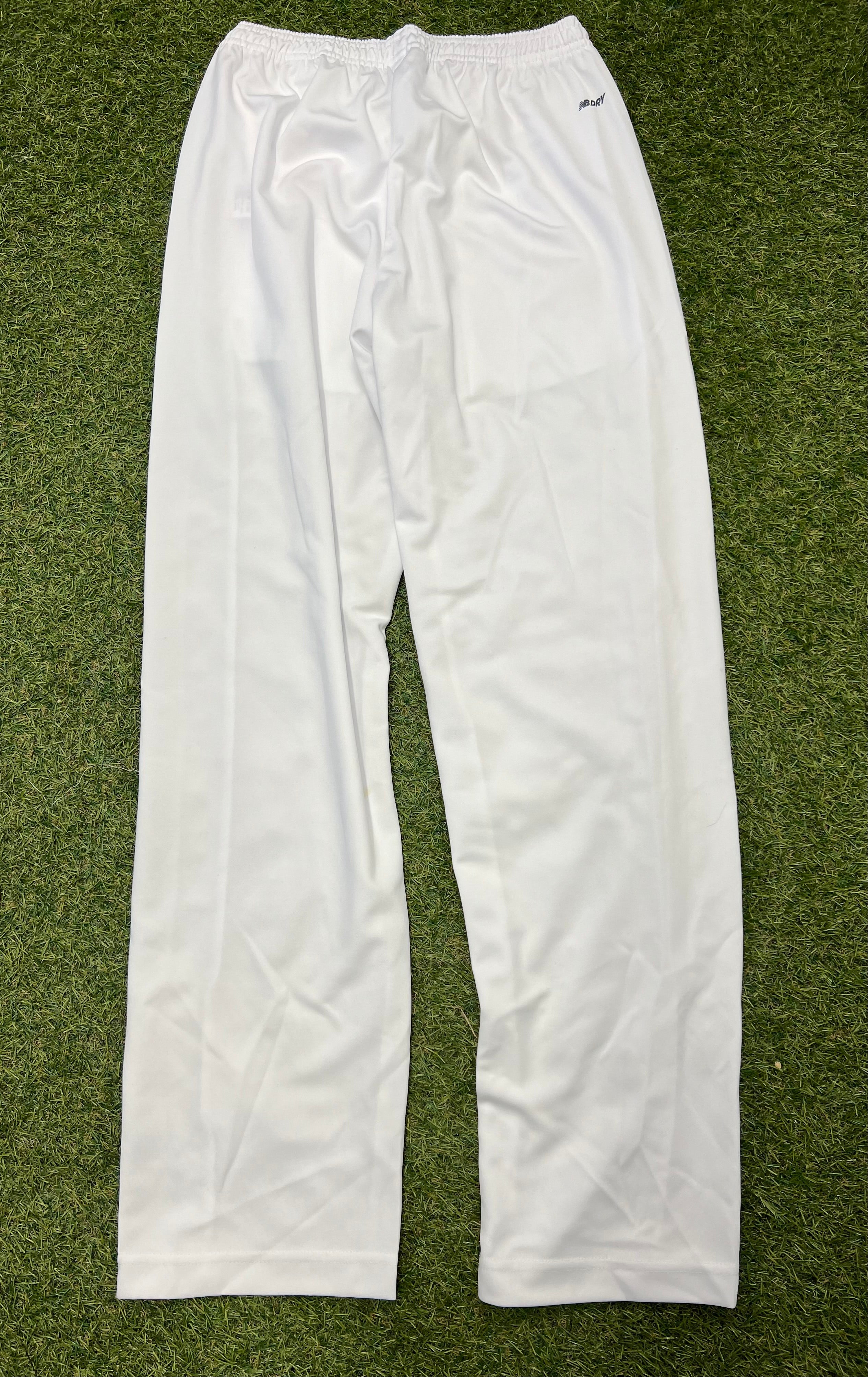 Back view of white New Balance cricket trousers showing elastic waistband