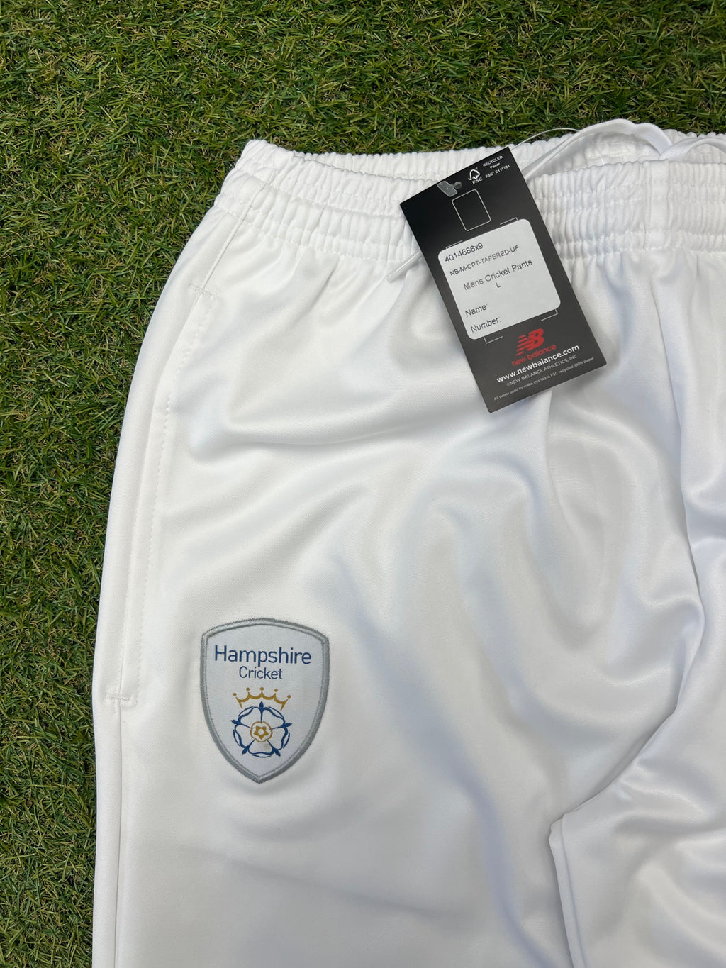 Close-up of Hampshire Cricket Club embroidered badge on front of white cricket trousers
