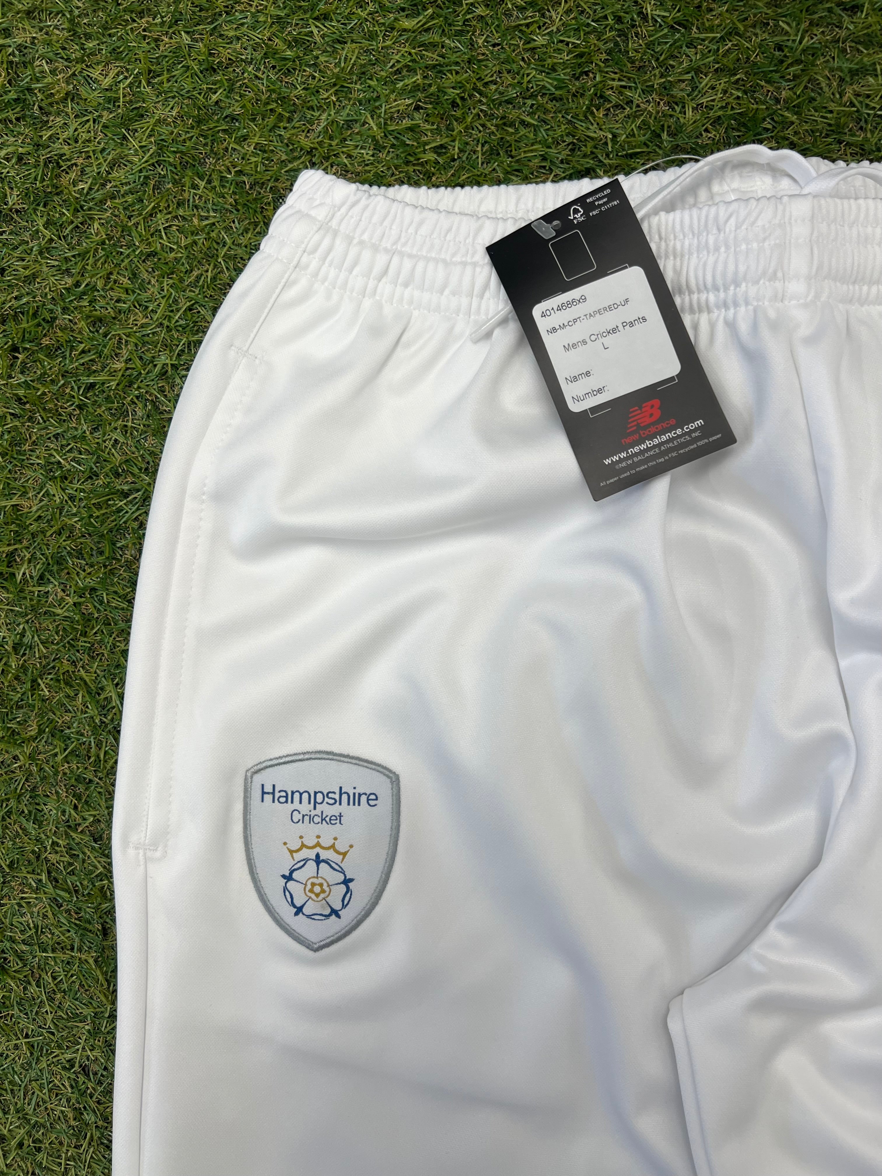 Close-up of Hampshire Cricket Club embroidered badge on front of white cricket trousers