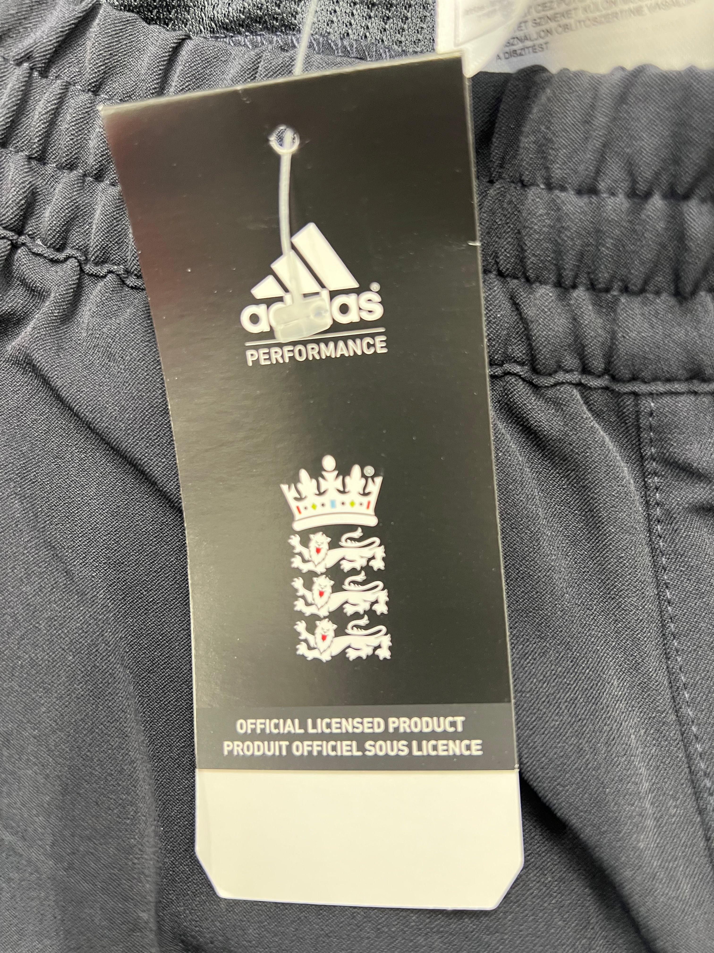 Close-up Adidas performance tag with England Cricket Board logo showing official licensed product branding