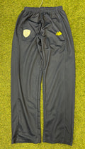 Front view of black New Balance Hampshire Cricket Tracksuit Bottoms on grass