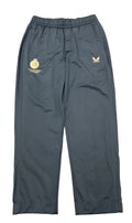 Front view of men's dark navy Castore Middlesex cricket tracksuit bottoms on grass