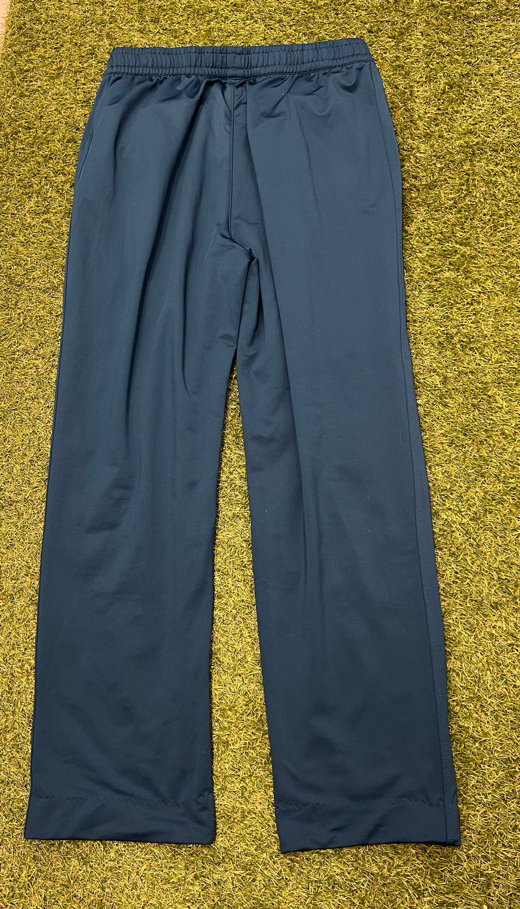 Rear view of men's dark navy Castore cricket tracksuit bottoms showing clean lines and elastic waistband