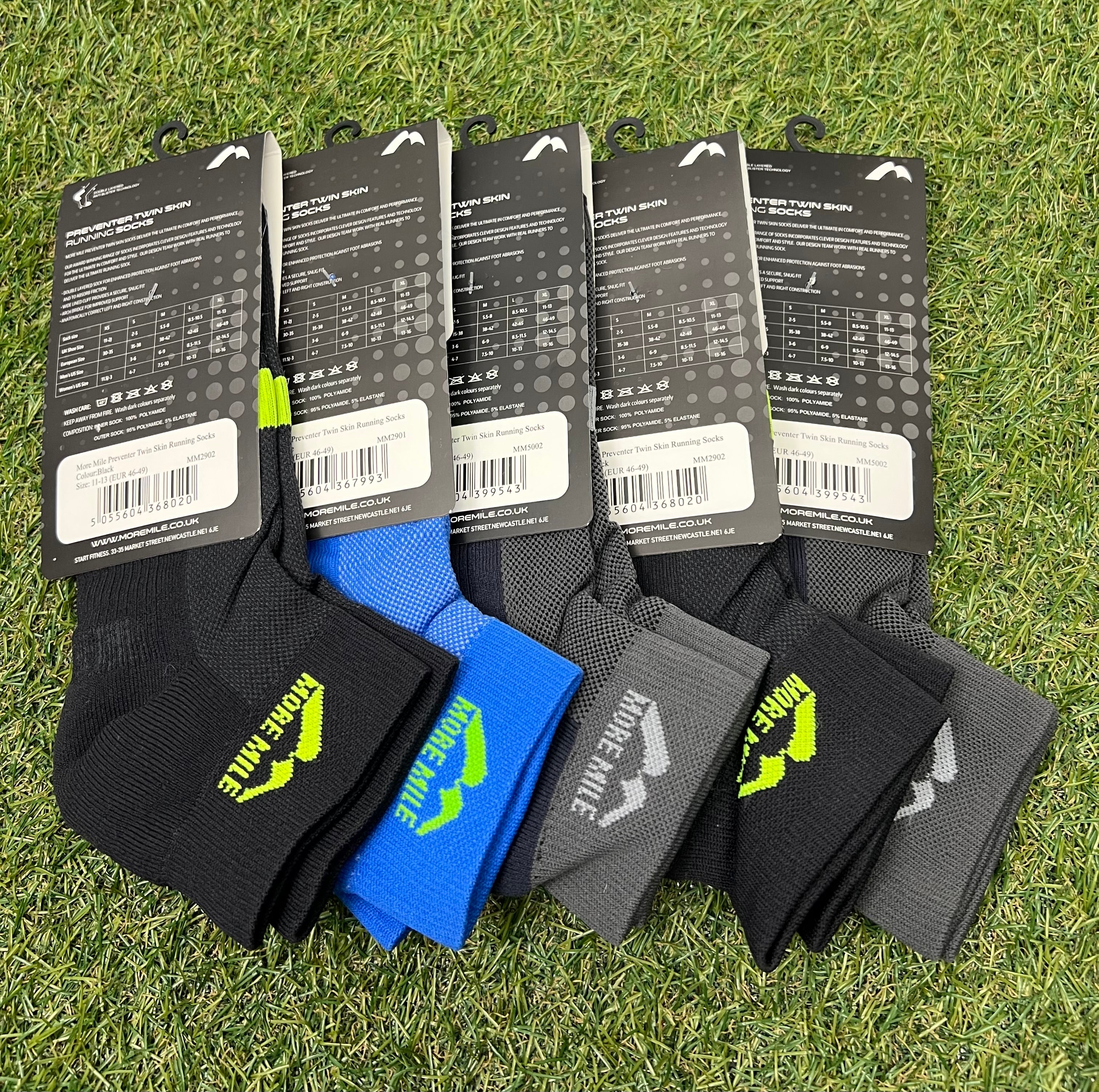 Rear view of five pairs of More Mile Preventer Twin Skin Running Socks displaying size, care instructions and barcode labels