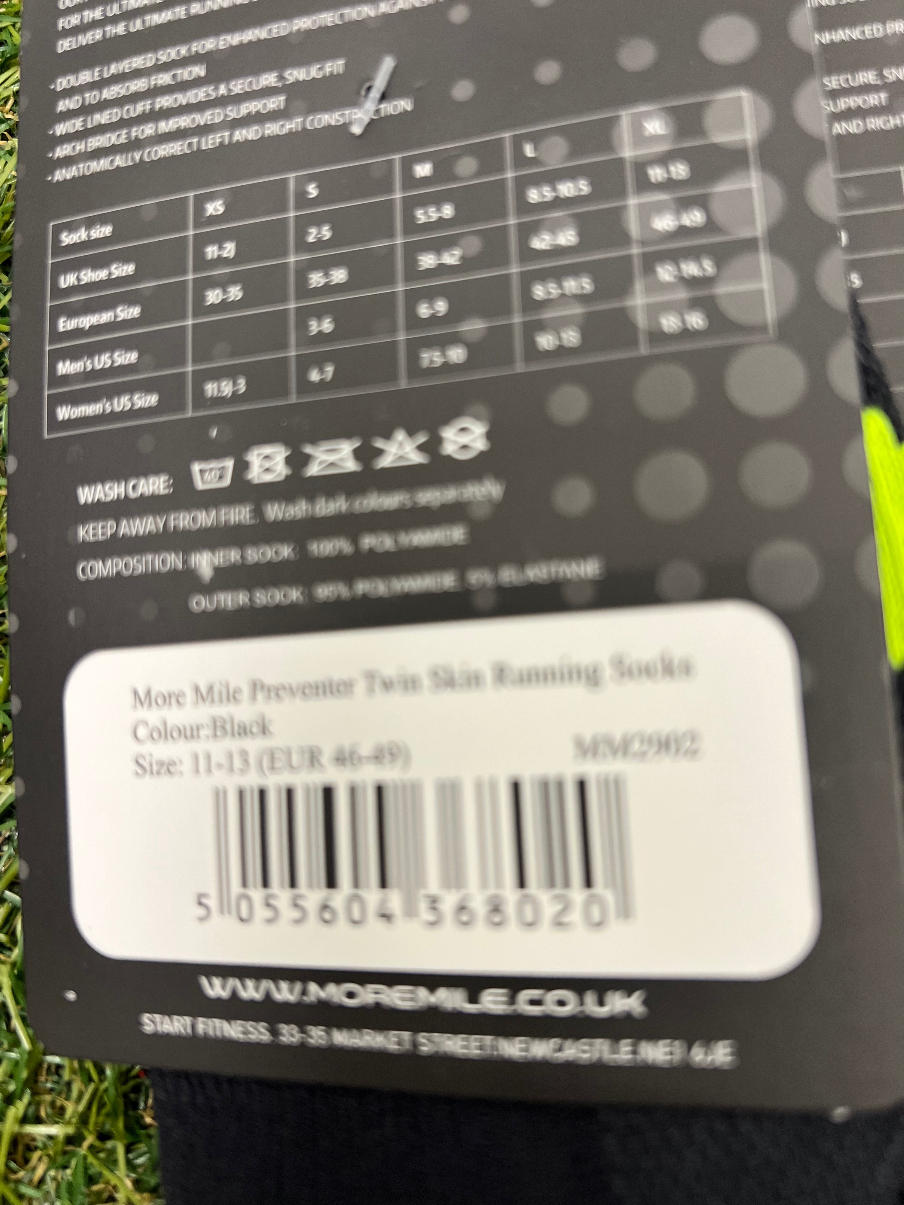 Close-up of sock size guide and care instructions on packaging of More Mile Preventer Twin Skin Running Socks