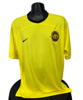 Front view of Nike Malaysia yellow football jersey with embroidered badge