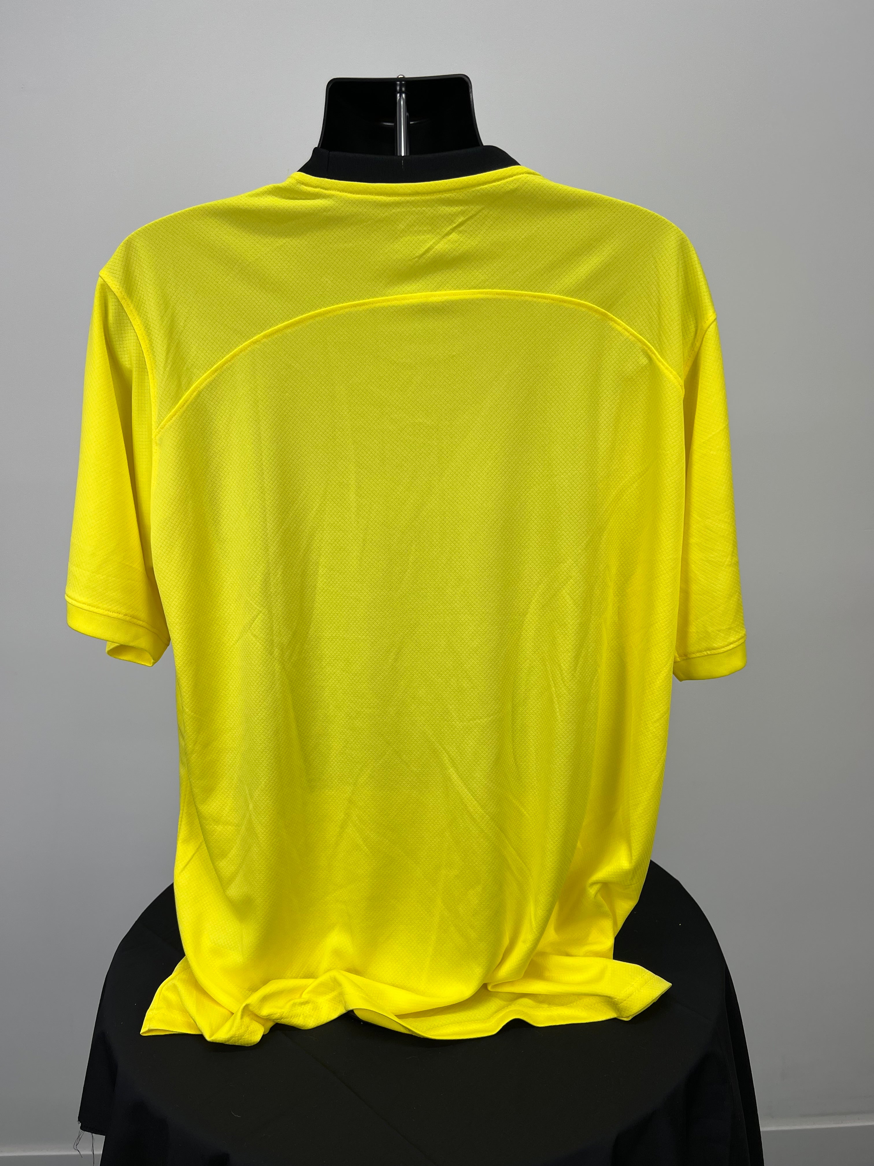 Back view of men's yellow Malaysia football jersey showing plain fabric with black collar detail