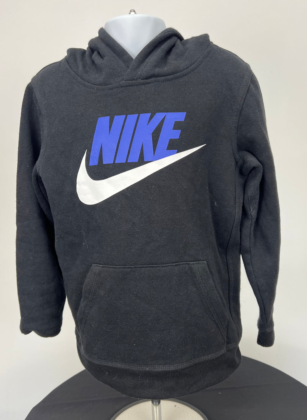 Front view of black Nike kids' hoodie with blue and white logo and kangaroo pocket