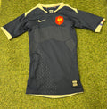 Front side of a black Nike FFR short sleeve rugby jersey with cream accents and red FFR emblem on chest