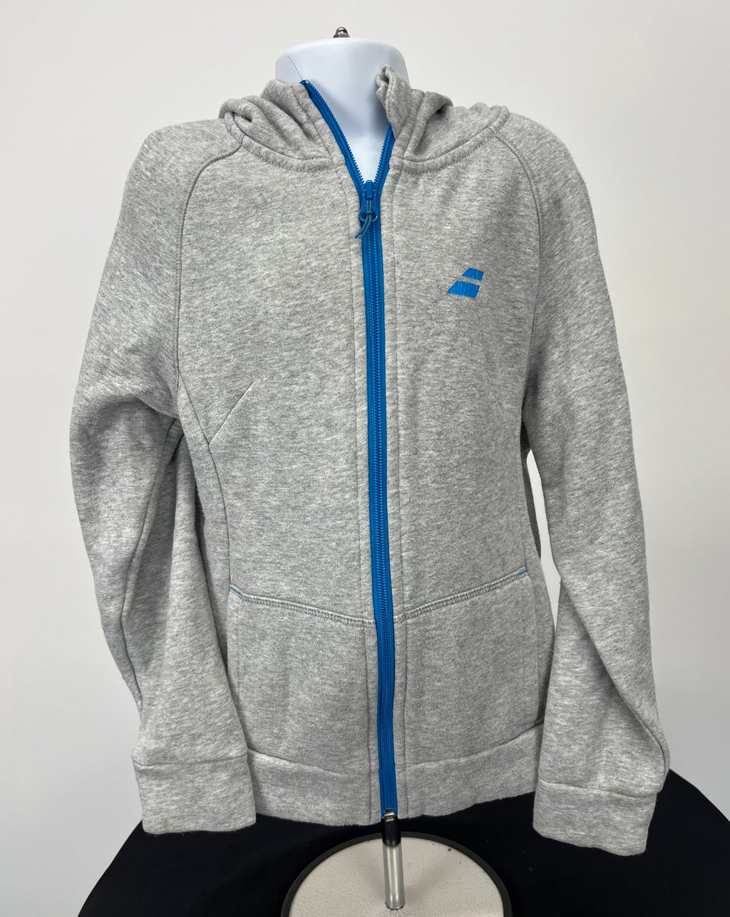 Front view of grey kids Babolat full zip hoodie with bright blue zipper and logo on chest
