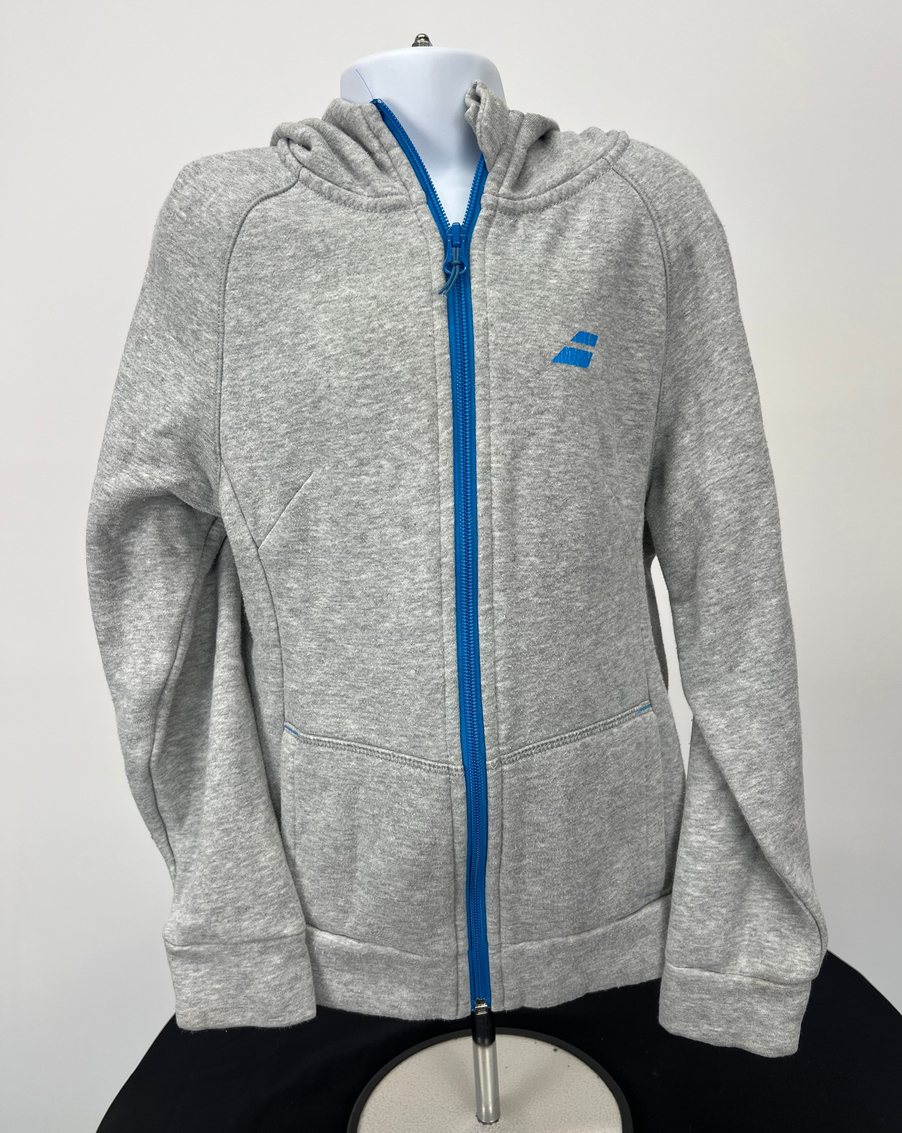 Front view of grey kids Babolat full zip hoodie with bright blue zipper and logo on chest