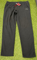 Men’s black Head tracksuit bottoms front view showing elasticated waistband with red and white drawstring and two side pockets