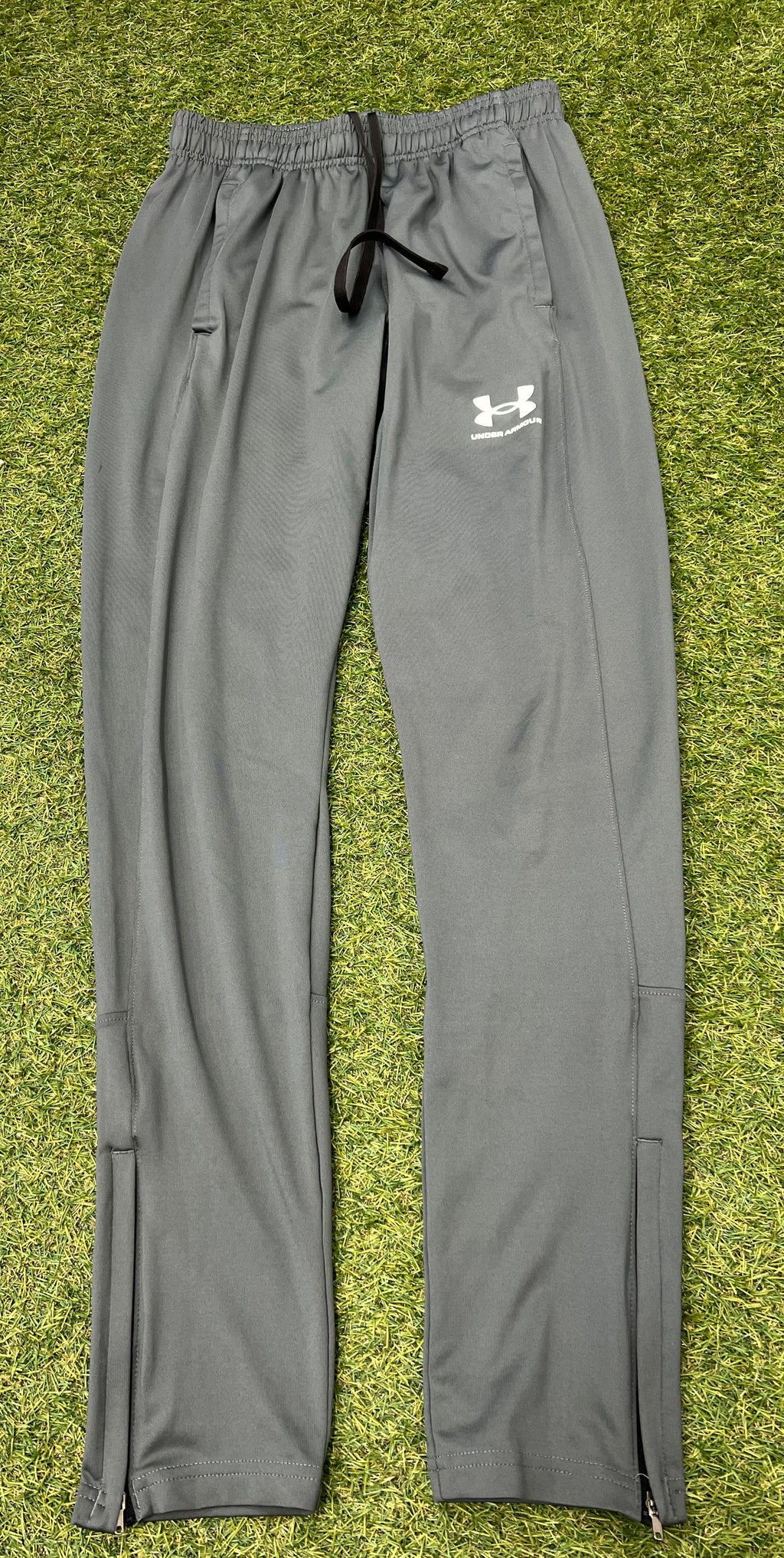 Rear view of grey Under Armour tracksuit trousers showing detailing and seam lines