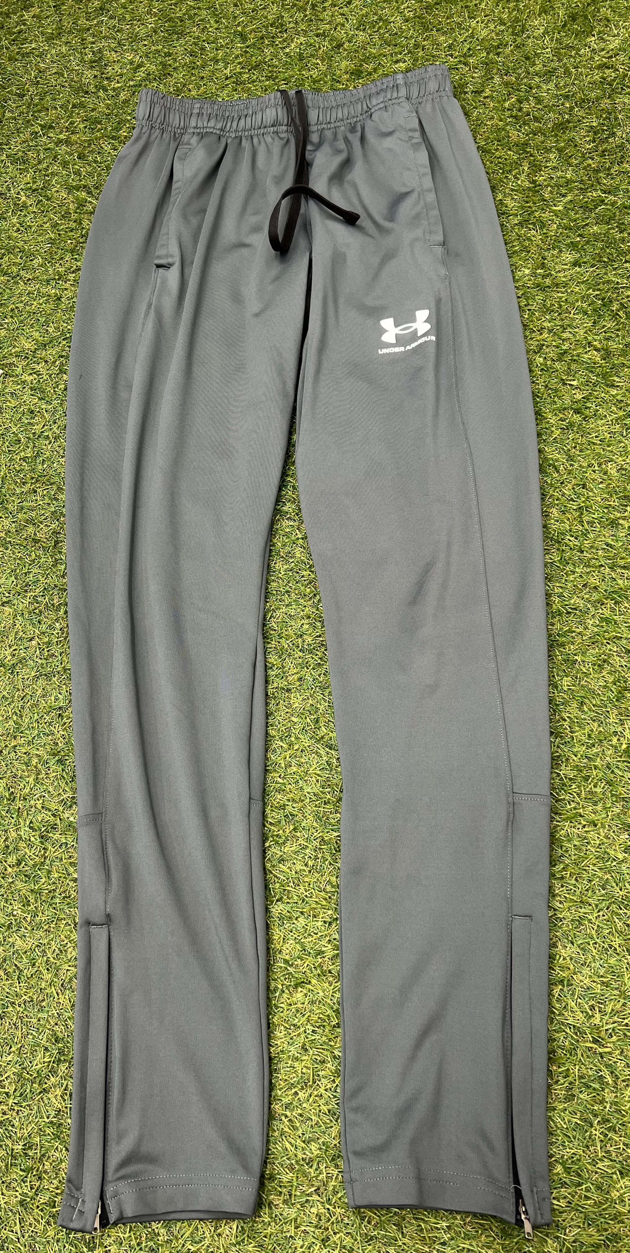 Rear view of grey Under Armour tracksuit trousers showing detailing and seam lines