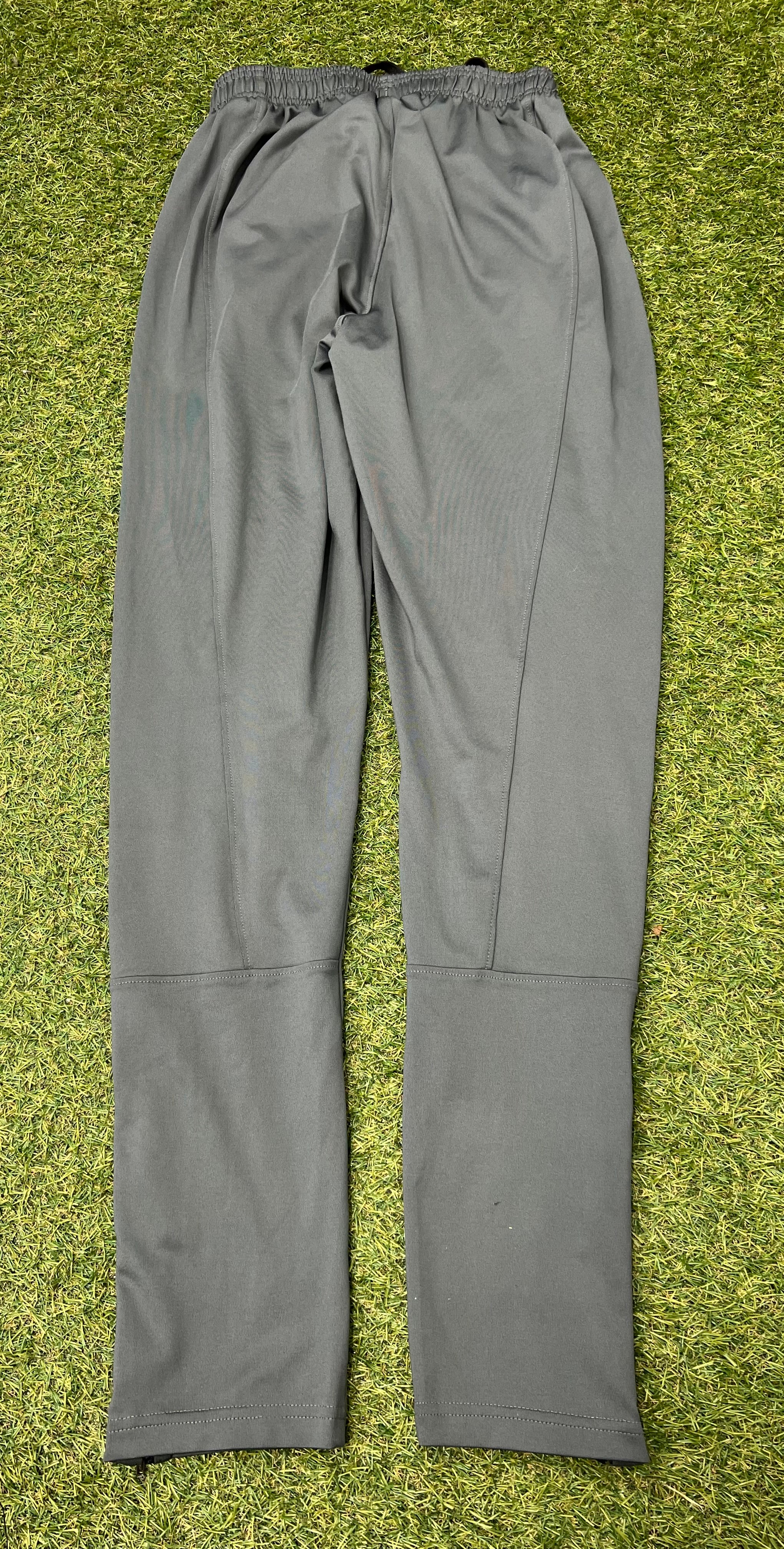 Close-up of grey tracksuit trousers ankle with zipped closure partially opened