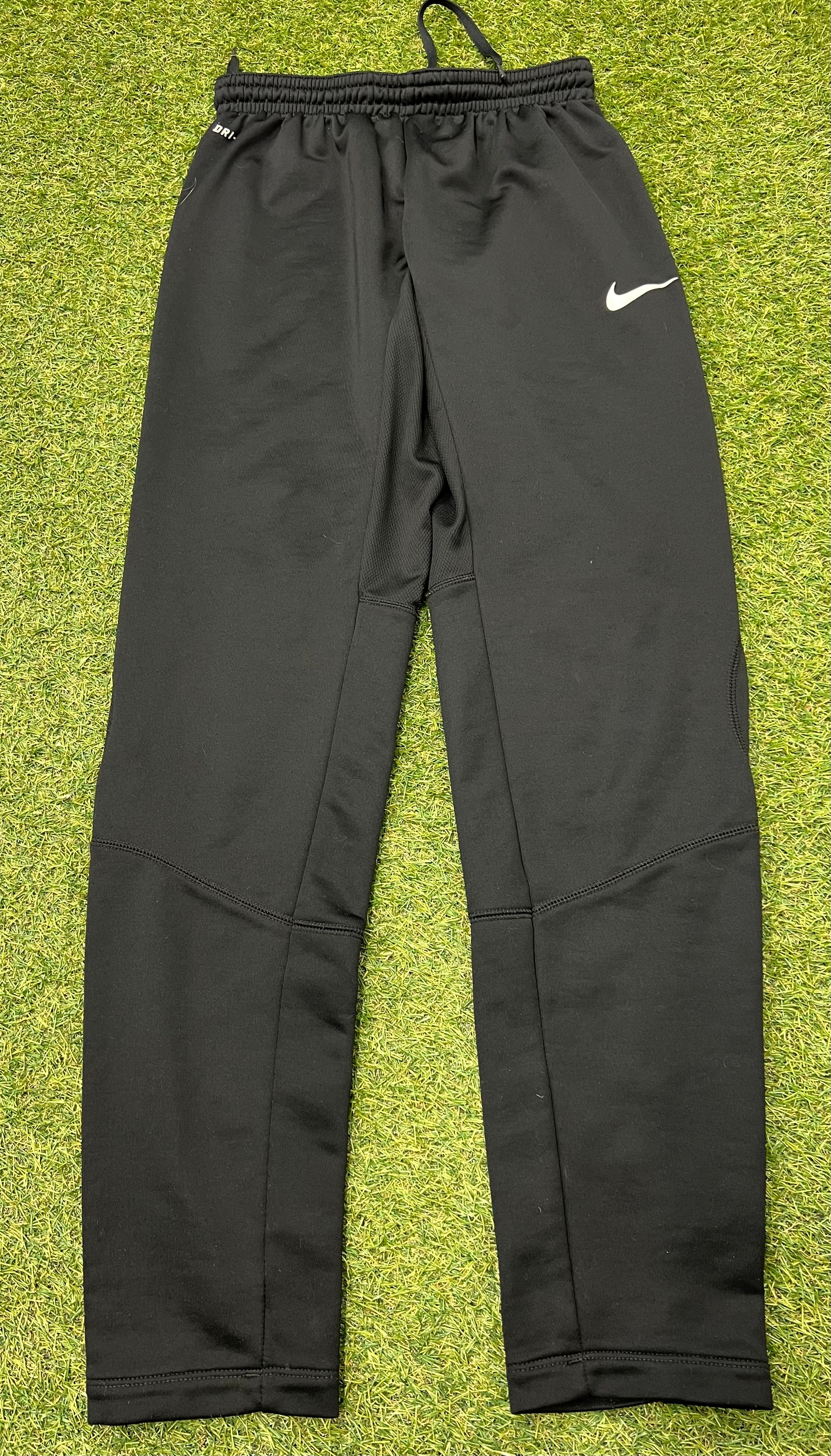 Rear close-up of mesh panels on black Nike Dri-FIT tracksuit bottoms
