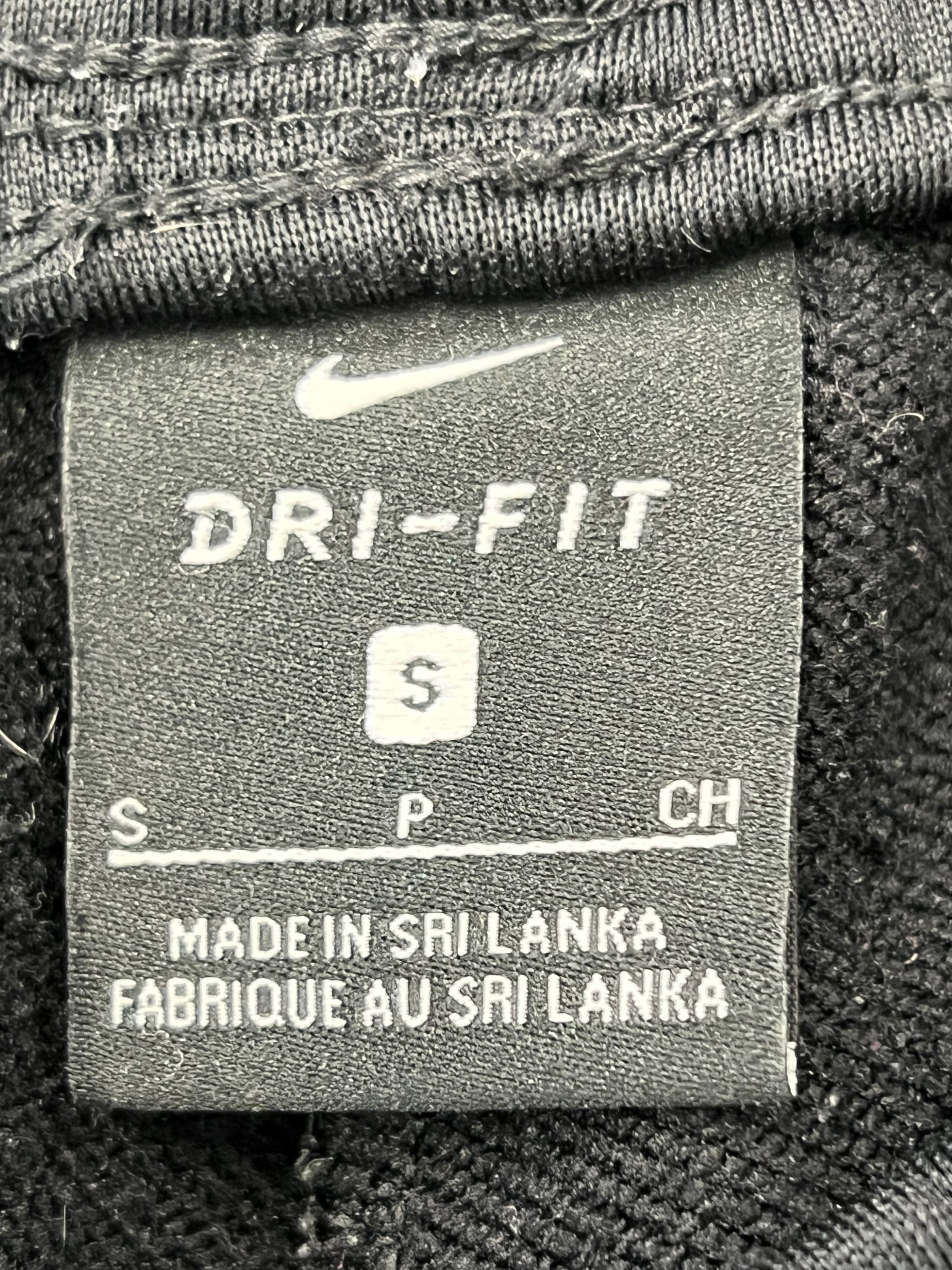 Close-up of Nike Dri-FIT label inside navy tracksuit bottoms