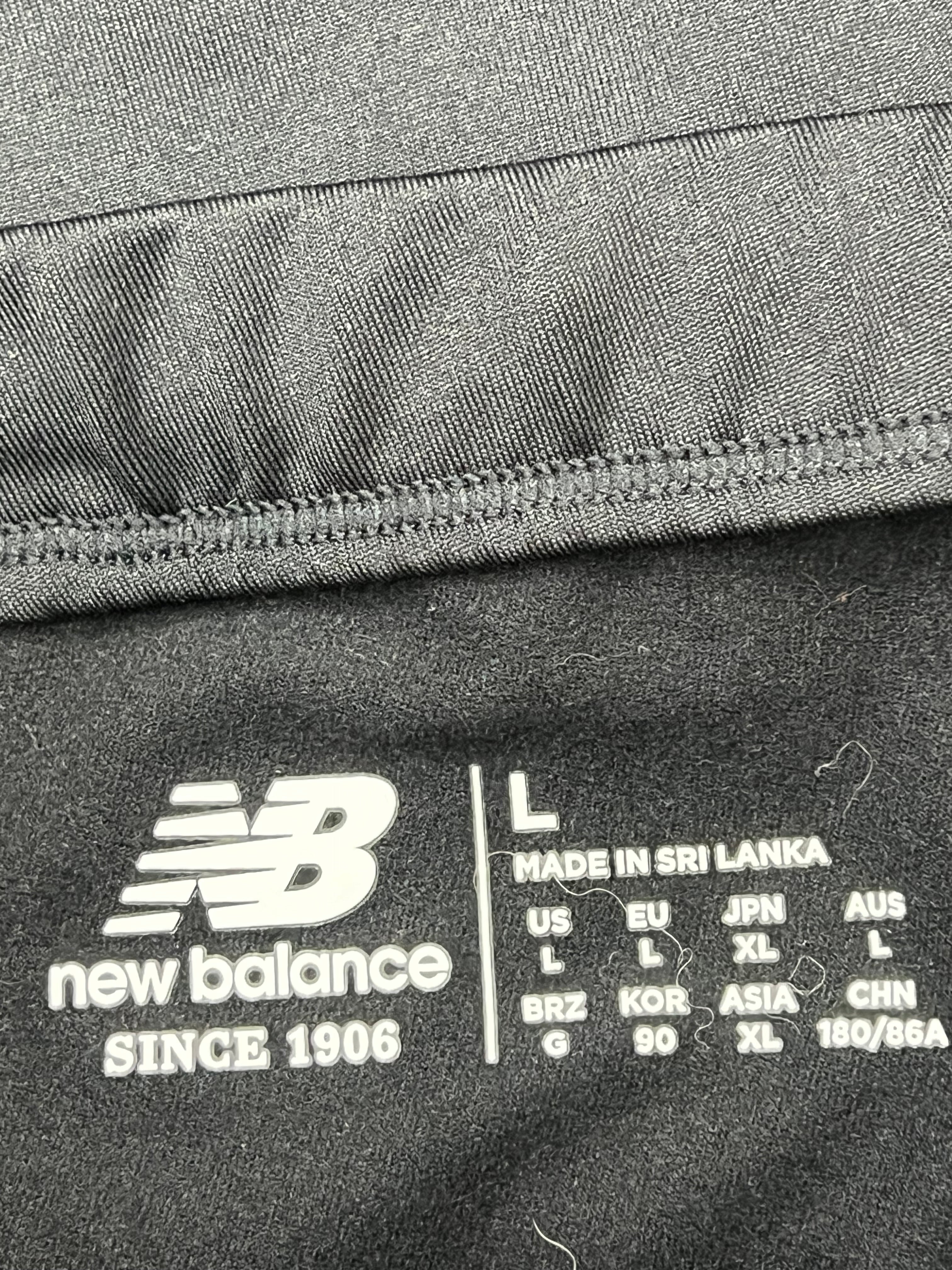 Close-up of New Balance logo and garment size information printed inside waistband