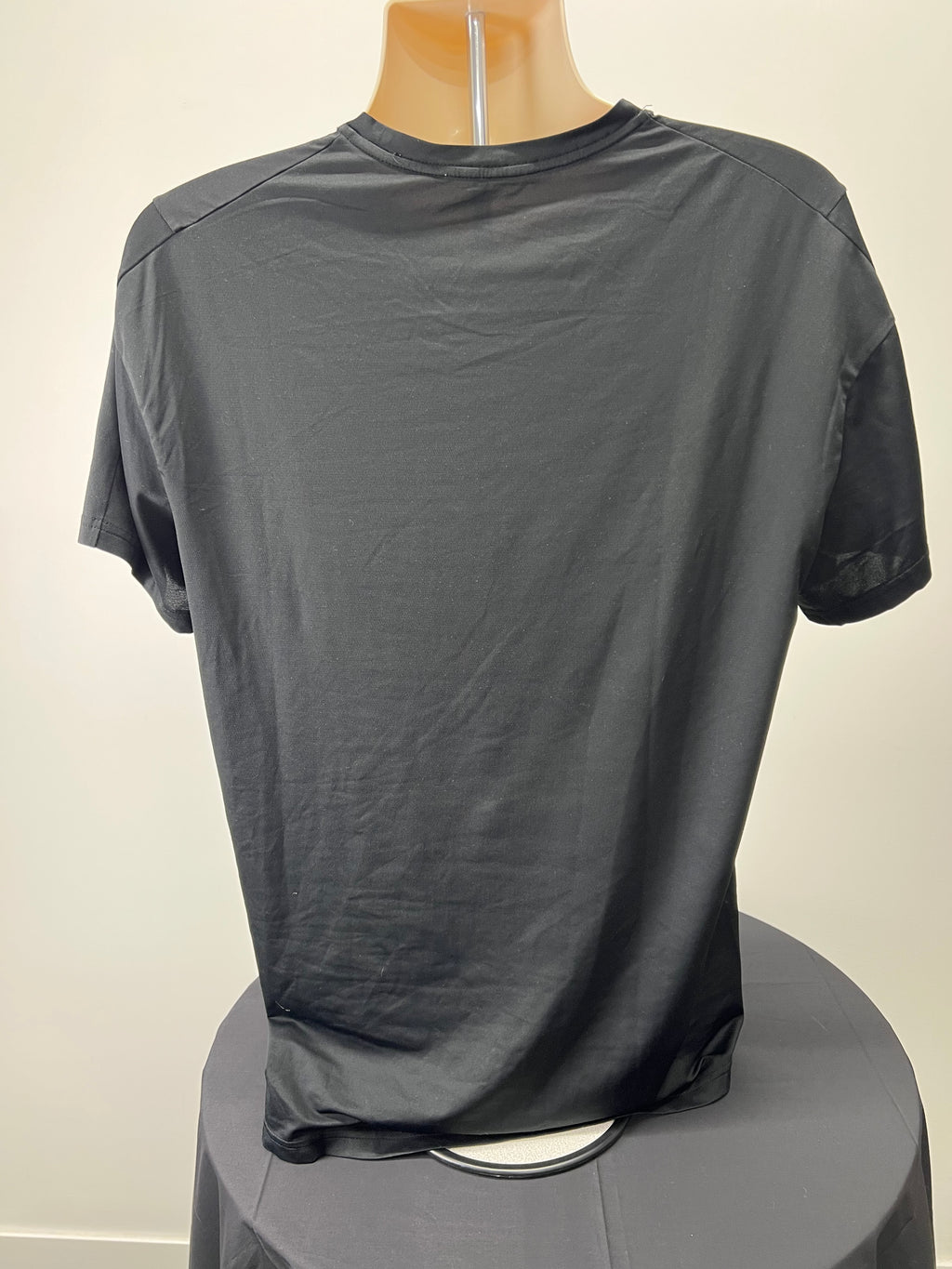 Back view of a black Nike Dri-FIT t-shirt displayed on a mannequin showing smooth fabric and relaxed fit