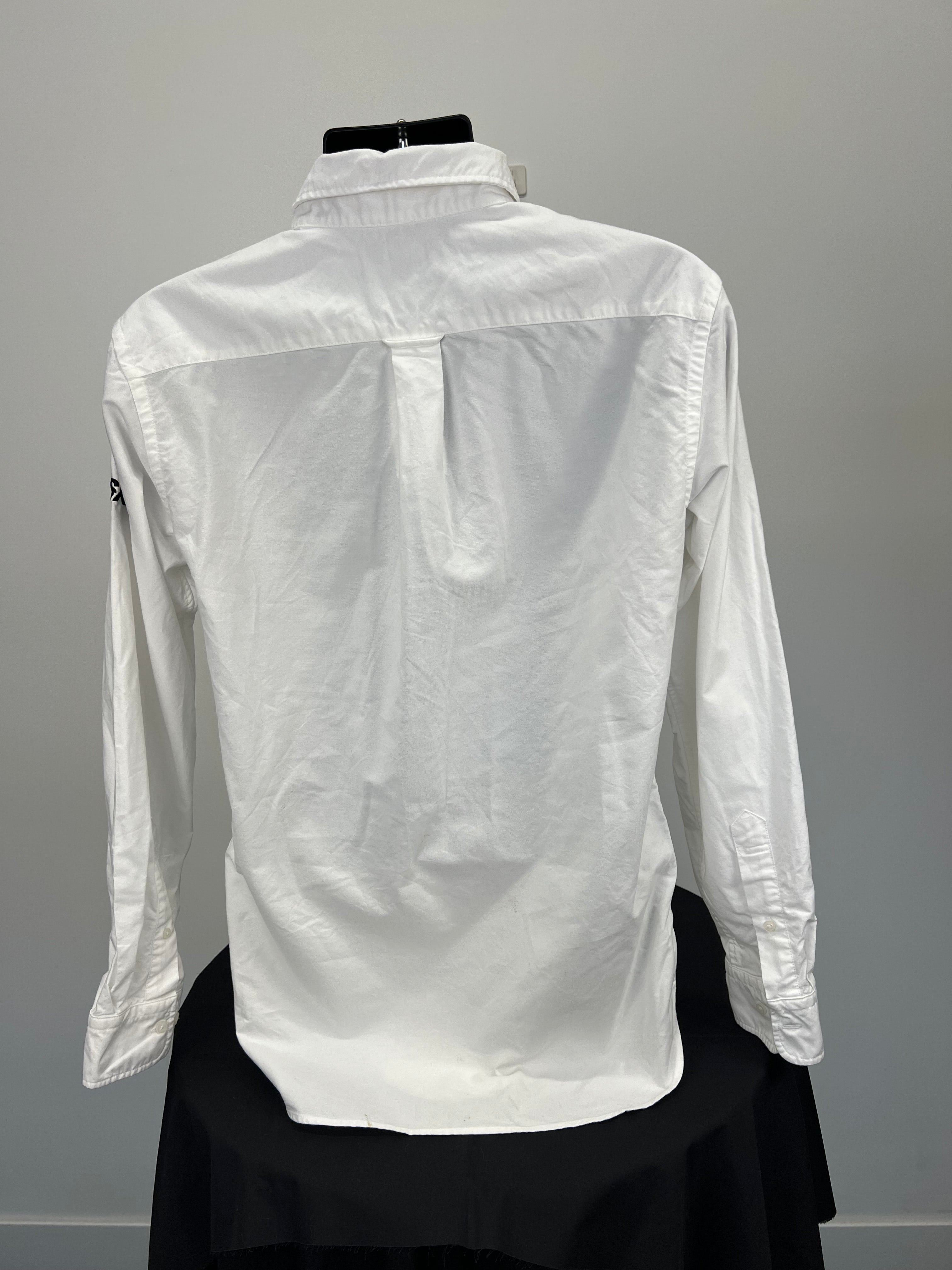 Back view of plain white cotton shirt showing pleat detail