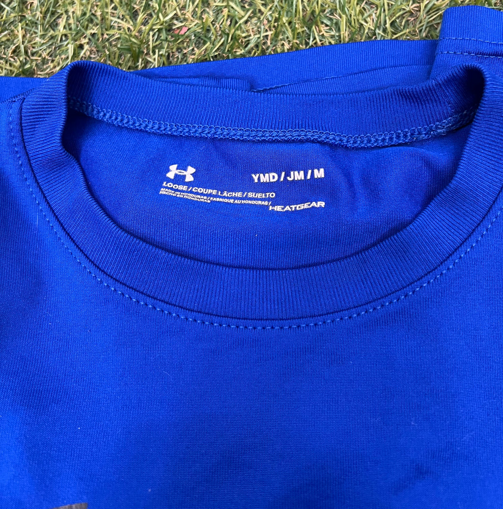 Close-up view of blue Under Armour kids T-shirt neckline showing HeatGear fabric and loose fit label