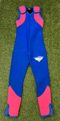 Front view of blue sleeveless wetsuit with bright pink panels on shoulders and lower legs laid on grass
