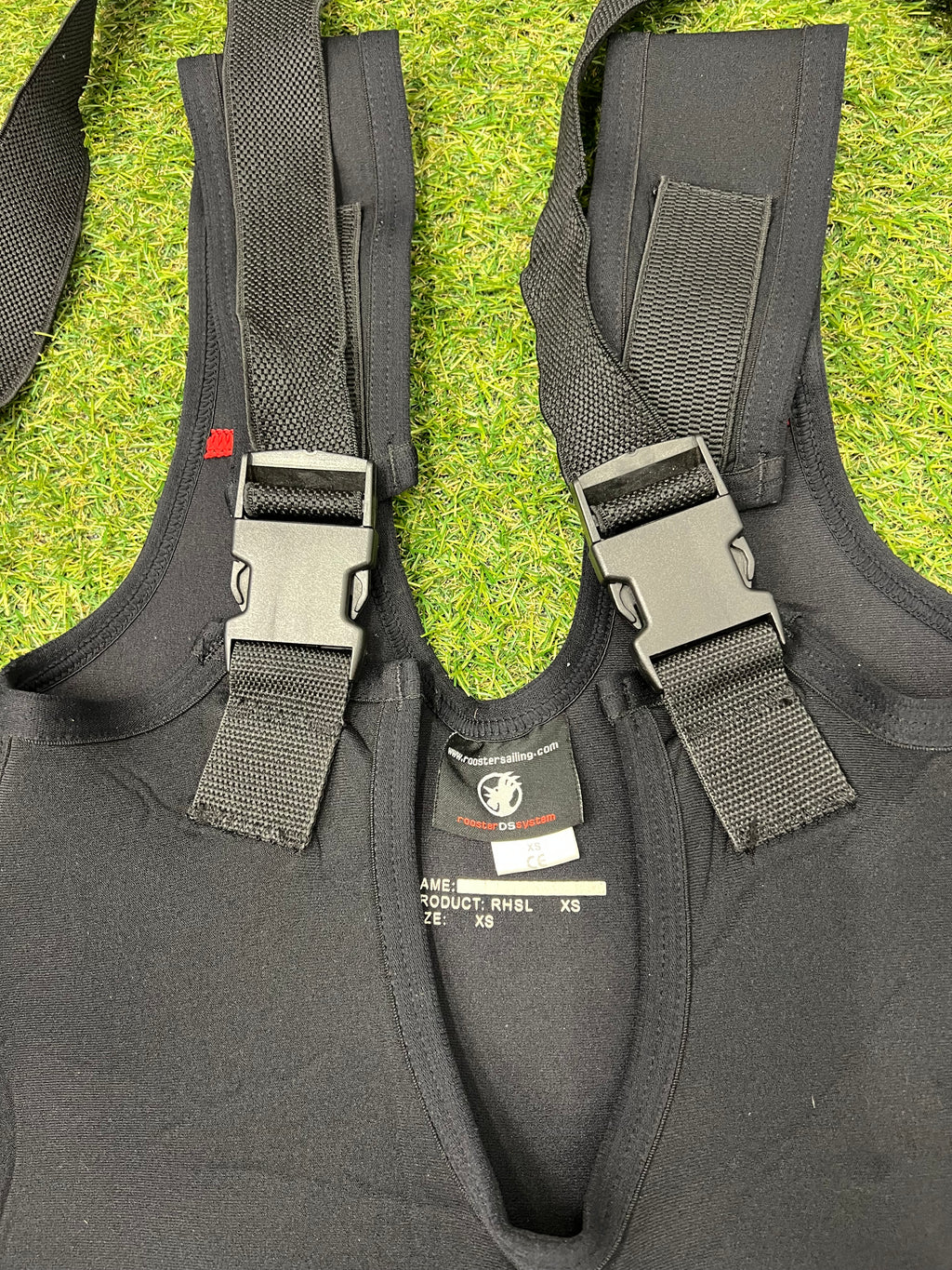 Close-up of black adjustable shoulder straps and buckles on Rooster sailing bib trousers