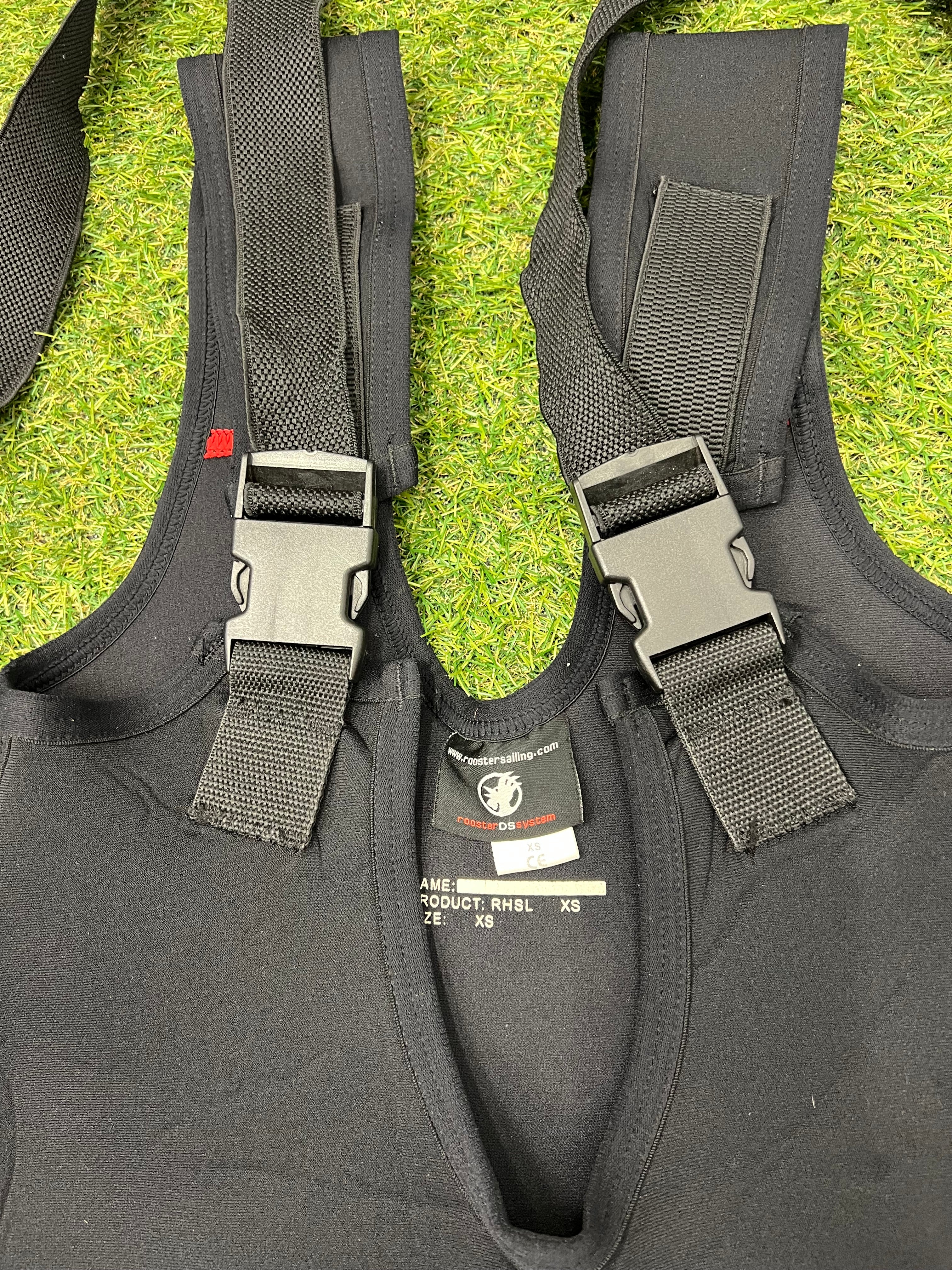 Close-up of black adjustable shoulder straps and buckles on Rooster sailing bib trousers