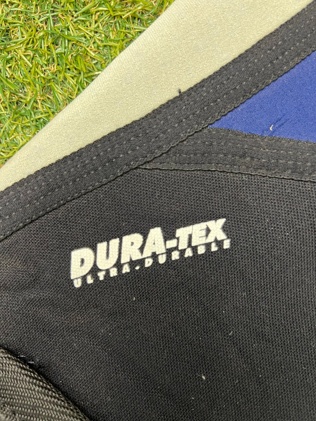 Close-up of Dura-Tex ultra-durable fabric logo patch on the black neoprene section of the wetsuit