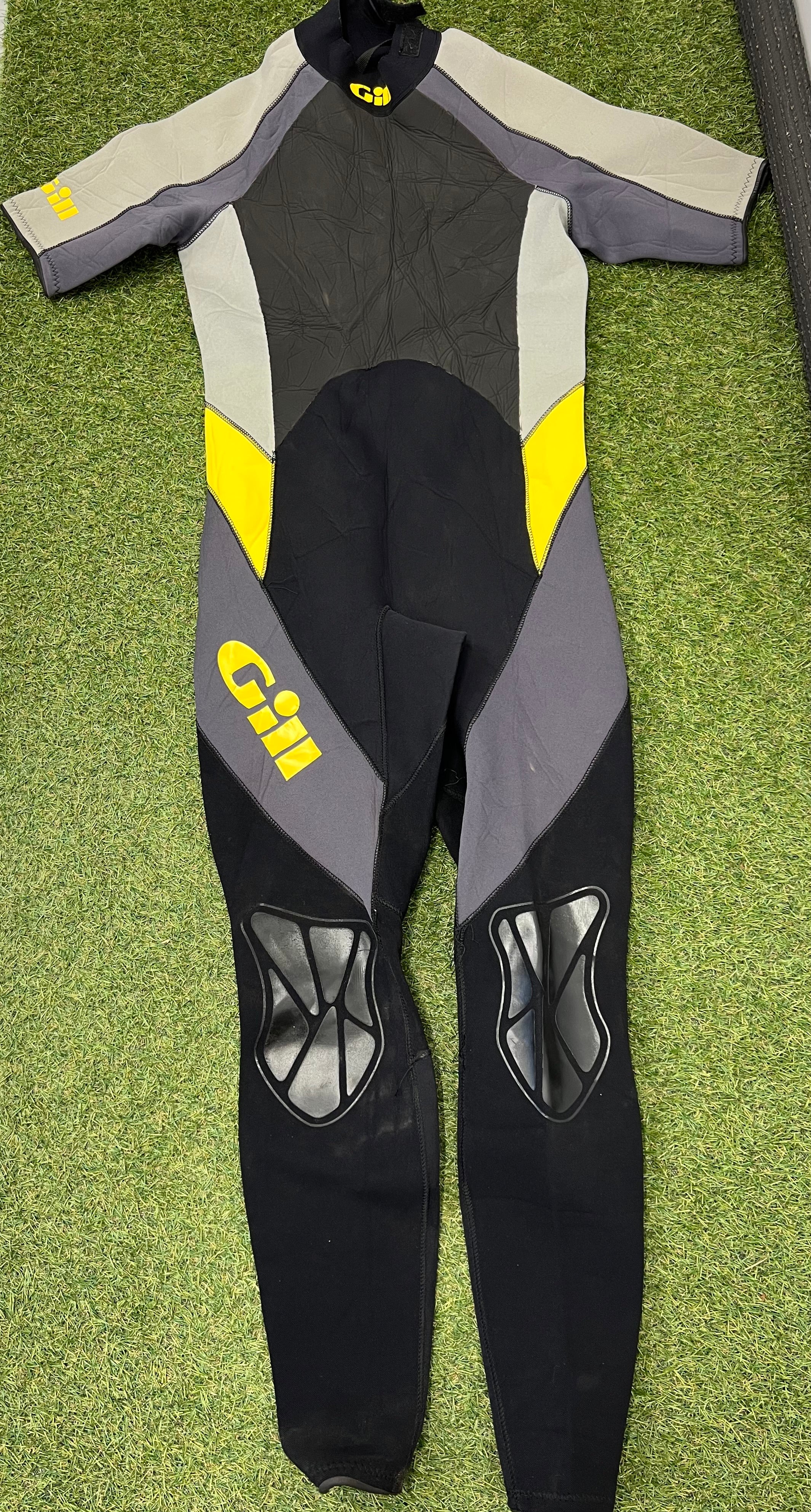 Back view of Gill short arm wetsuit showing reinforced knee pads and grey, black and yellow design