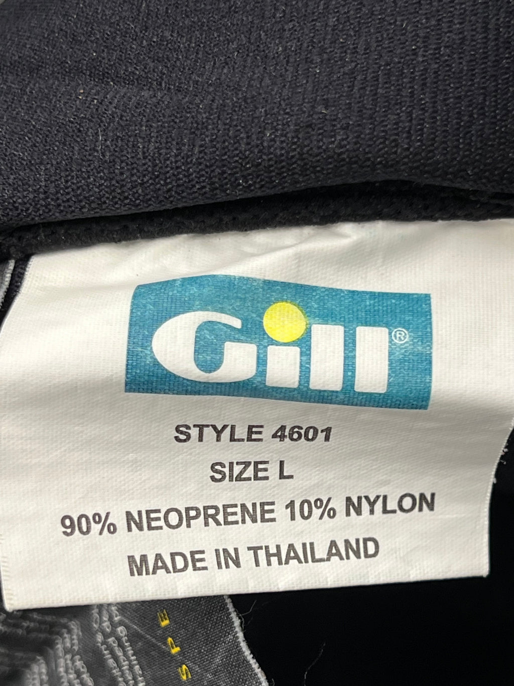 Close-up of informational inside label describing fabric construction, glued and blindstitch seams and Olympic sailors testing