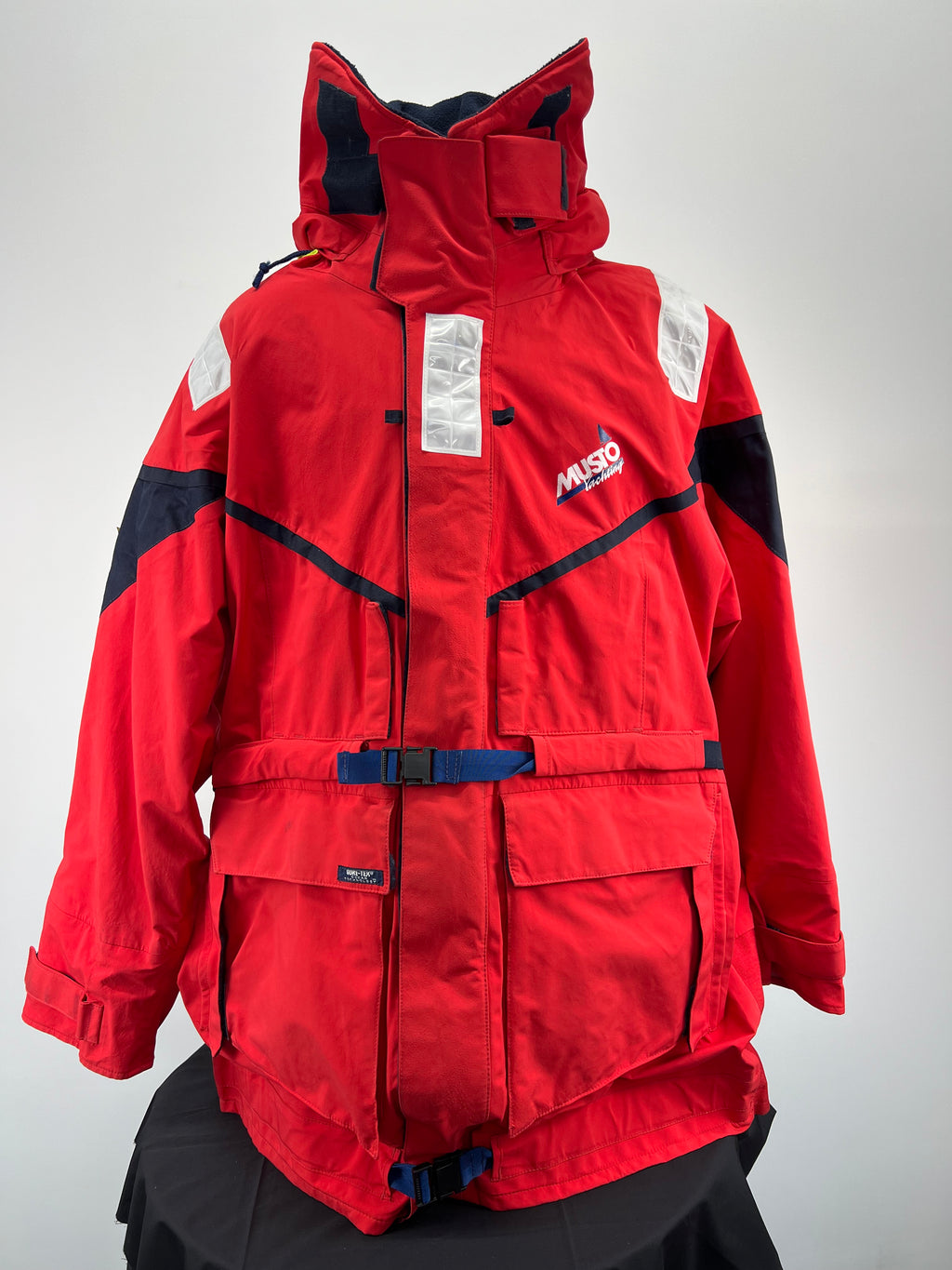 Front view of Musto HPX red sailing jacket with navy and reflective details