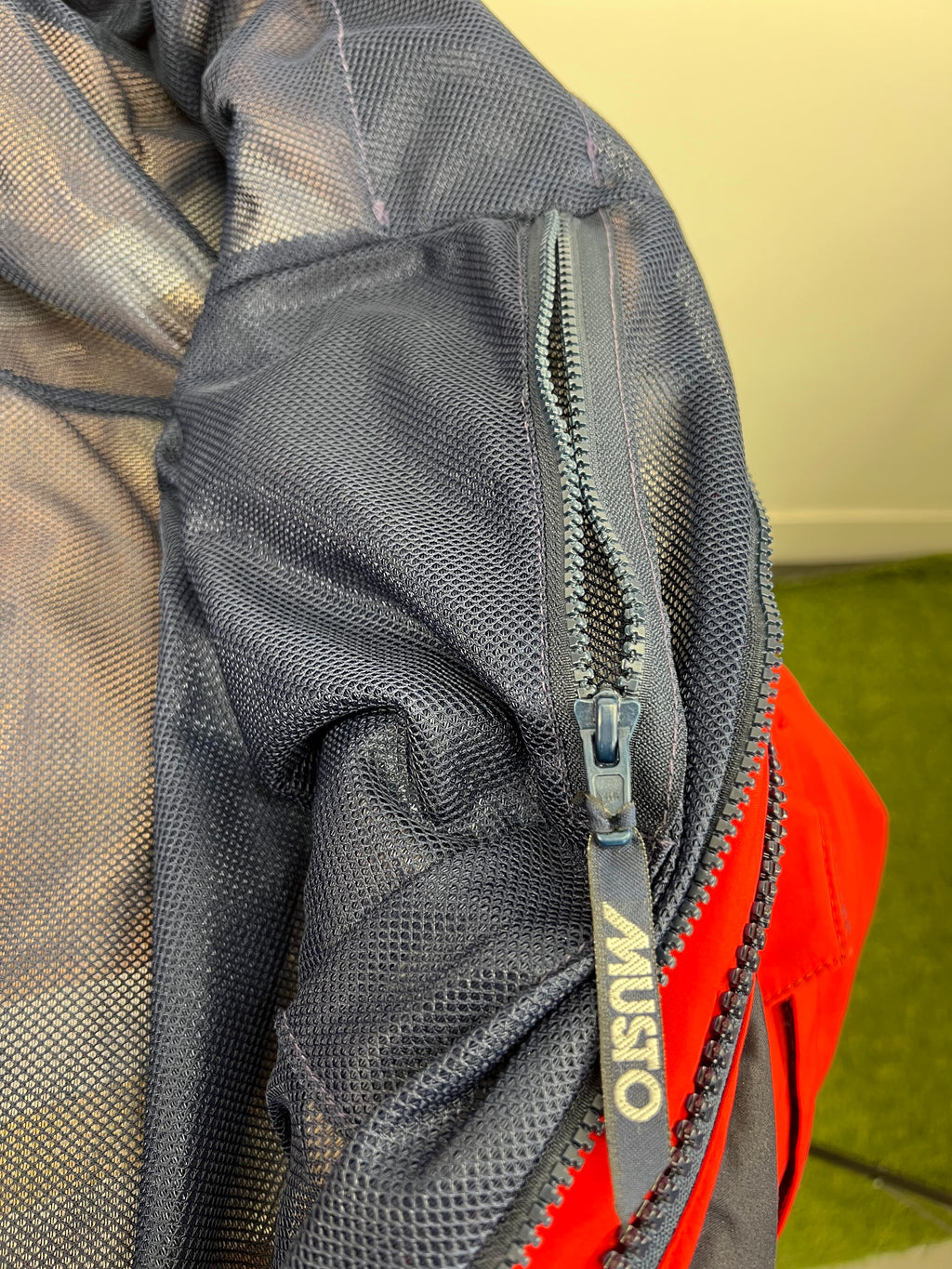 Adjustable yellow hood lining with reflective strip on red sailing jacket