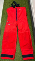 Front view of Musto HPX Ocean Tech waterproof sailing trousers in bright red with adjustable black braces and thigh pocket.