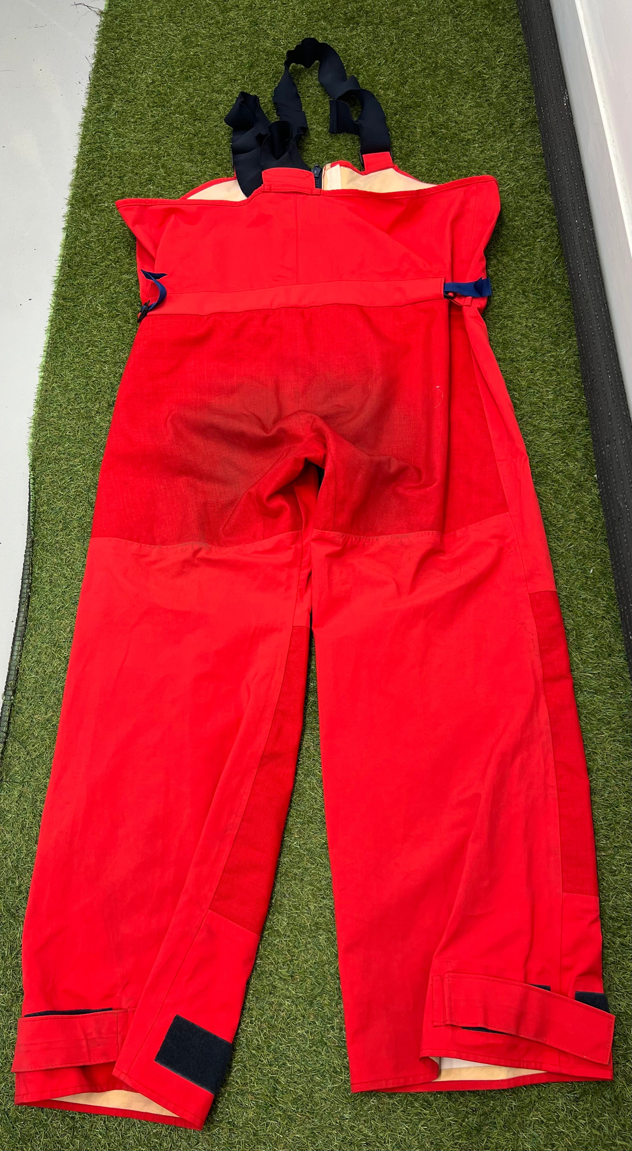 Rear view of Musto HPX trousers highlighting reinforced seat area and adjustable ankle velcro straps.