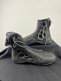 Pair of black Rooster Pro laced ankle strap boots with grey laces on black cloth background