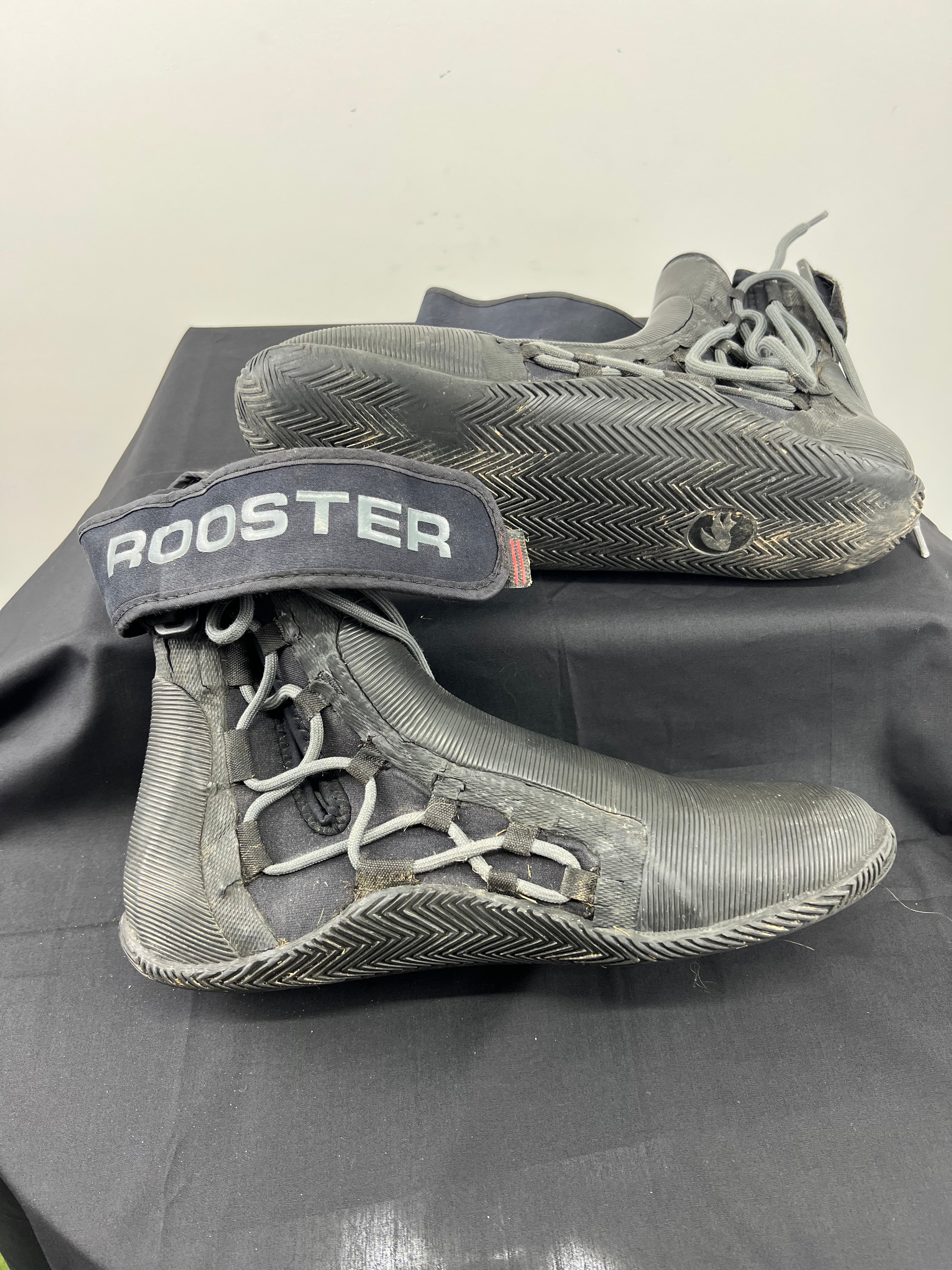 Side view of Rooster Pro boots showing textured sole and ankle strap with Rooster branding