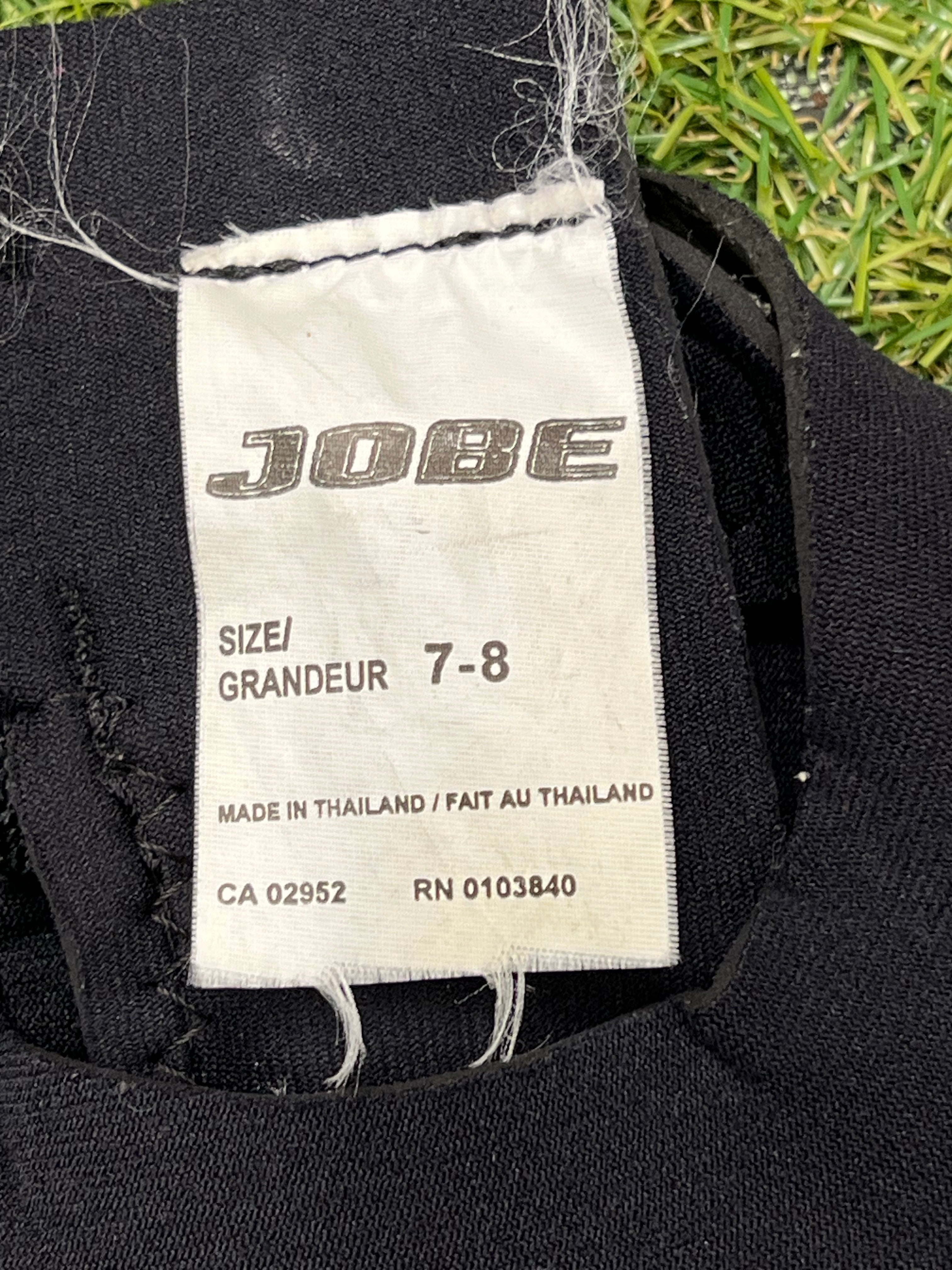 Close-up of Jobe label inside wetsuit indicating size 7-8, made in Thailand