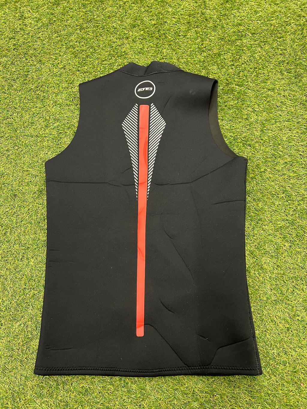Back view of Zone3 black sleeveless wetsuit vest showing red vertical stripe and white patterned accents