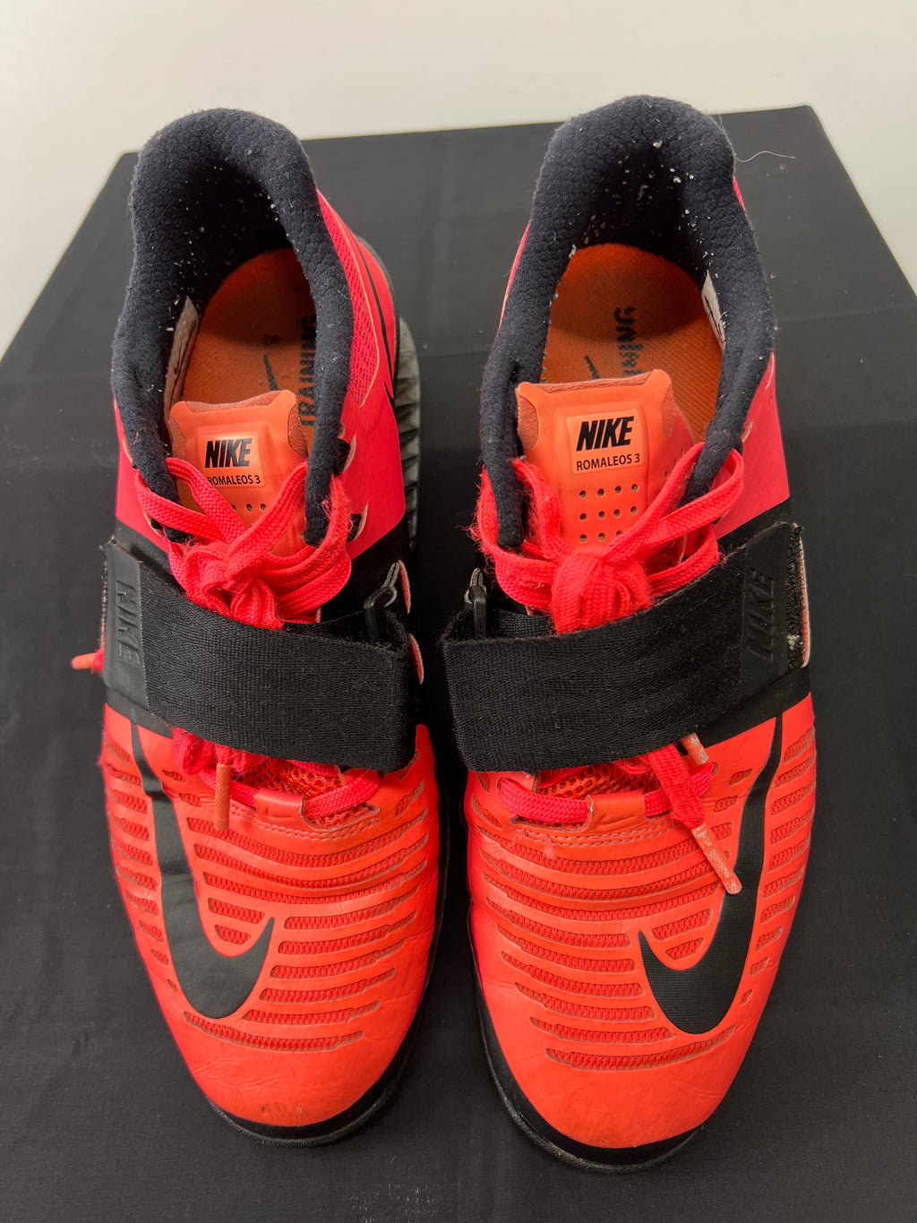 Pair of Nike Romaleos 3 weightlifting shoes in bright red and black with Flywire upper and adjustable straps viewed from the top