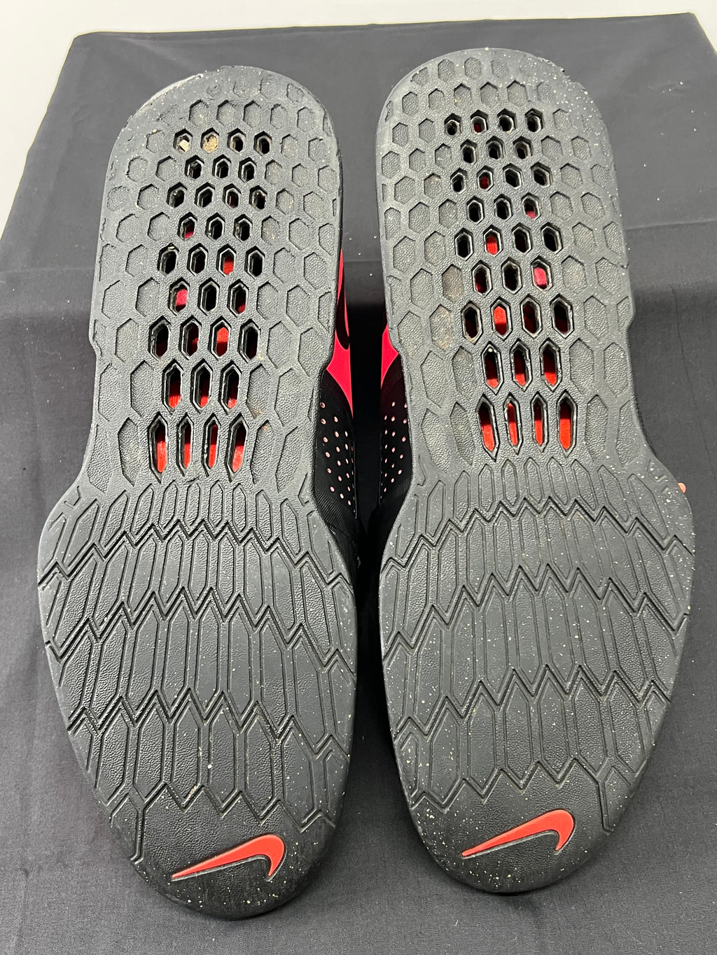 Outsoles of Nike Romaleos 3 shoes showing textured rubber sole with Nike swoosh and hexagonal grip pattern