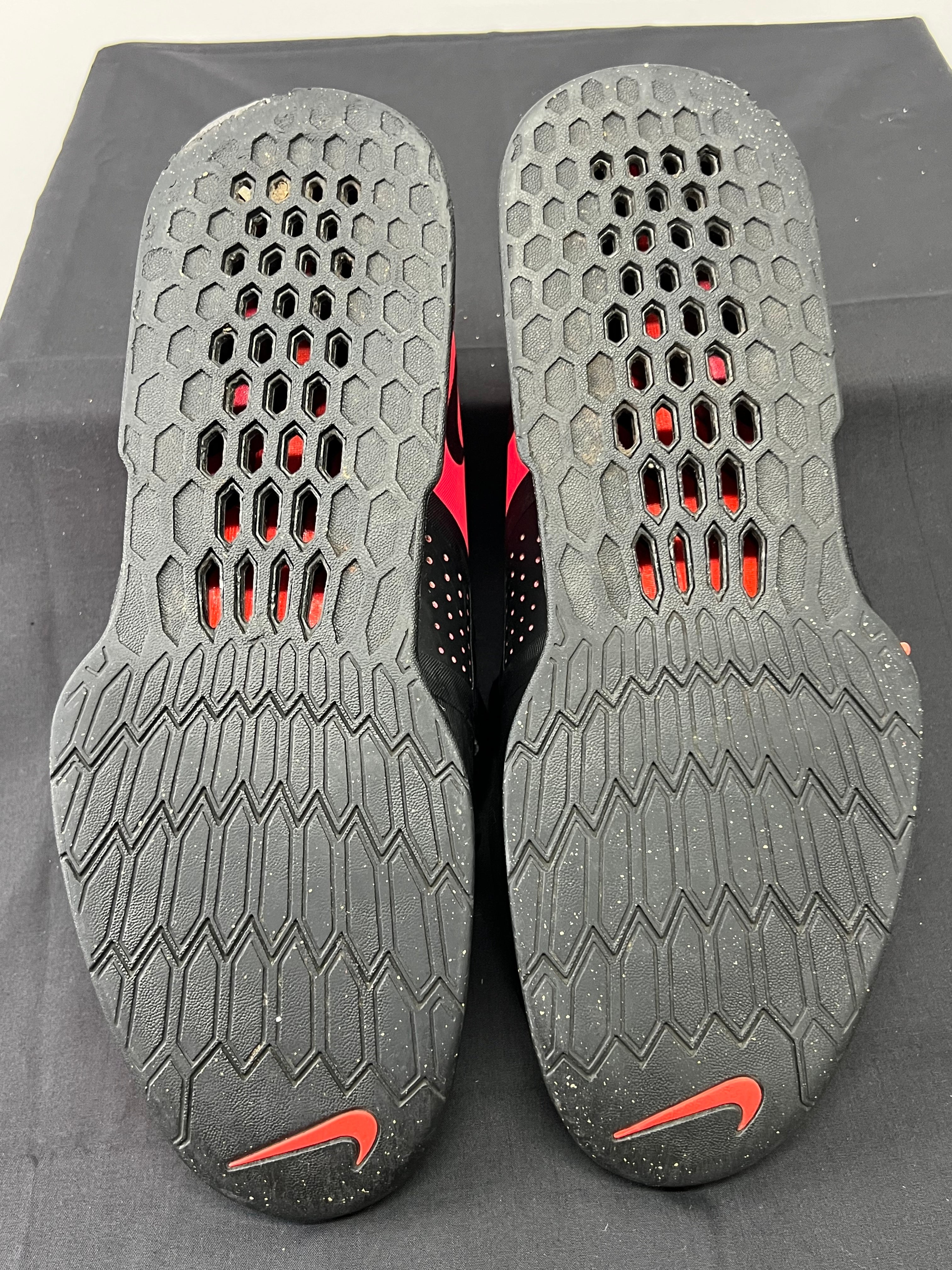 Outsoles of Nike Romaleos 3 shoes showing textured rubber sole with Nike swoosh and hexagonal grip pattern